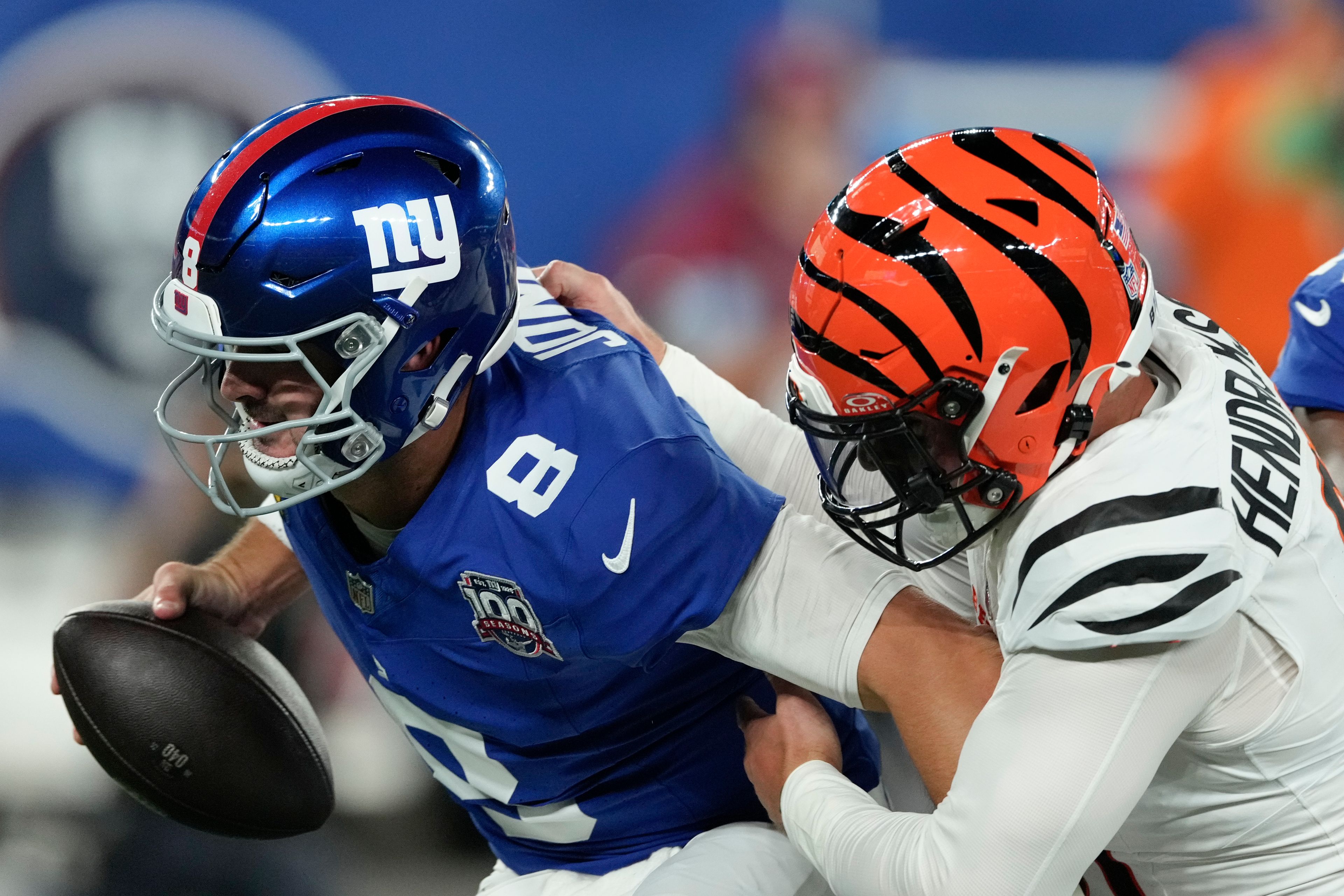 New York Giants quarterback Daniel Jones (8) is sacked by Cincinnati Bengals defensive end Trey Hendrickson (91) during the first half of an NFL football game, Sunday, Oct. 13, 2024, in East Rutherford, N.J. (AP Photo/Seth Wenig)