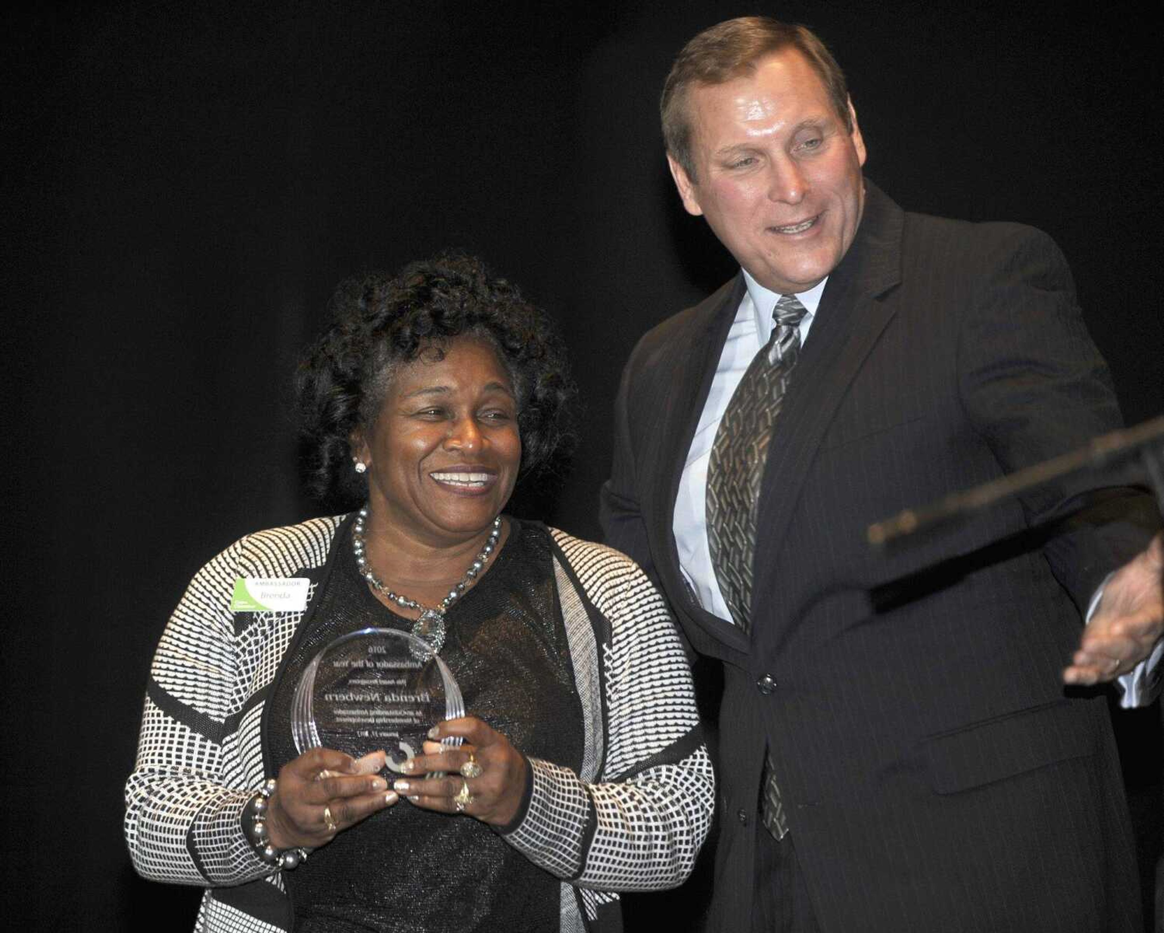 Brenda Newbern receives the Ambassador of the Year Award from Cape Girardeau Area Chamber of Commerce outgoing chairman Bob Neff at the chamber's annual dinner Friday at the Show Me Center.