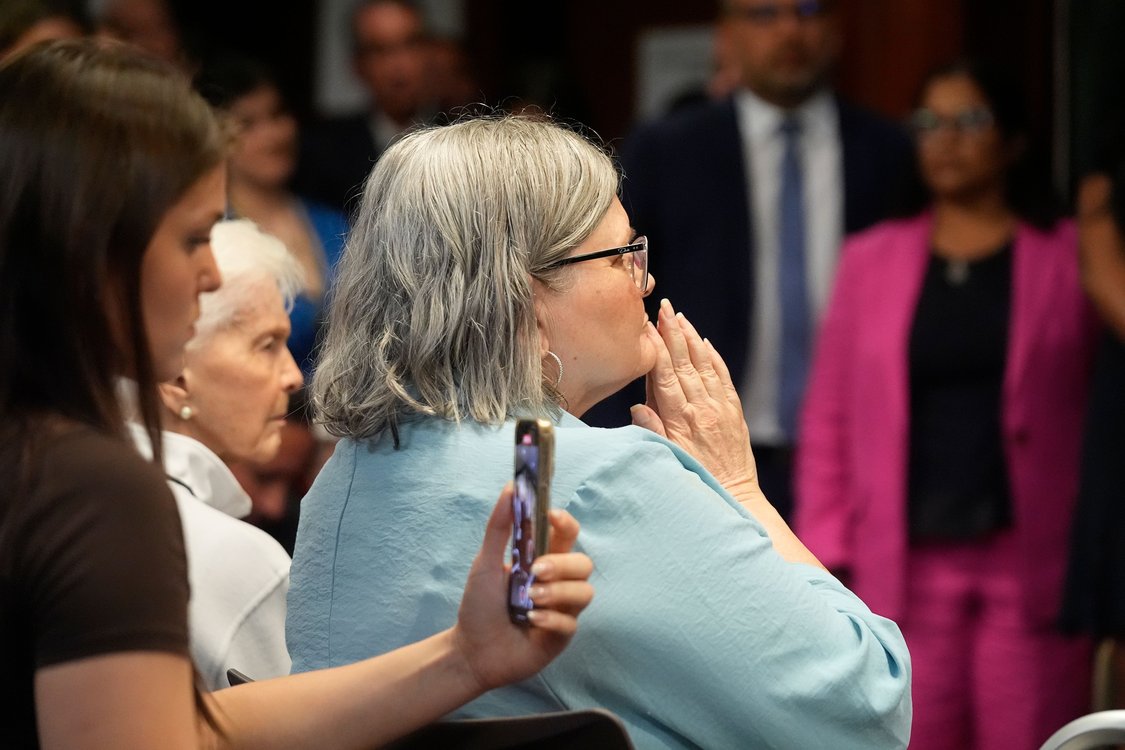 Diane Hernandez, Niece of Kitty Menendez, holds her hands as Los Angeles County District Attorney George Gascon announces he will ask a judge to resentence Erik and Lyle Menendez, two brothers serving life sentences for killing their parents, at a news conference at the Hall of Justice in Los Angeles on Thursday, Oct. 24, 2024, in Los Angeles. (AP Photo/Damian Dovarganes)