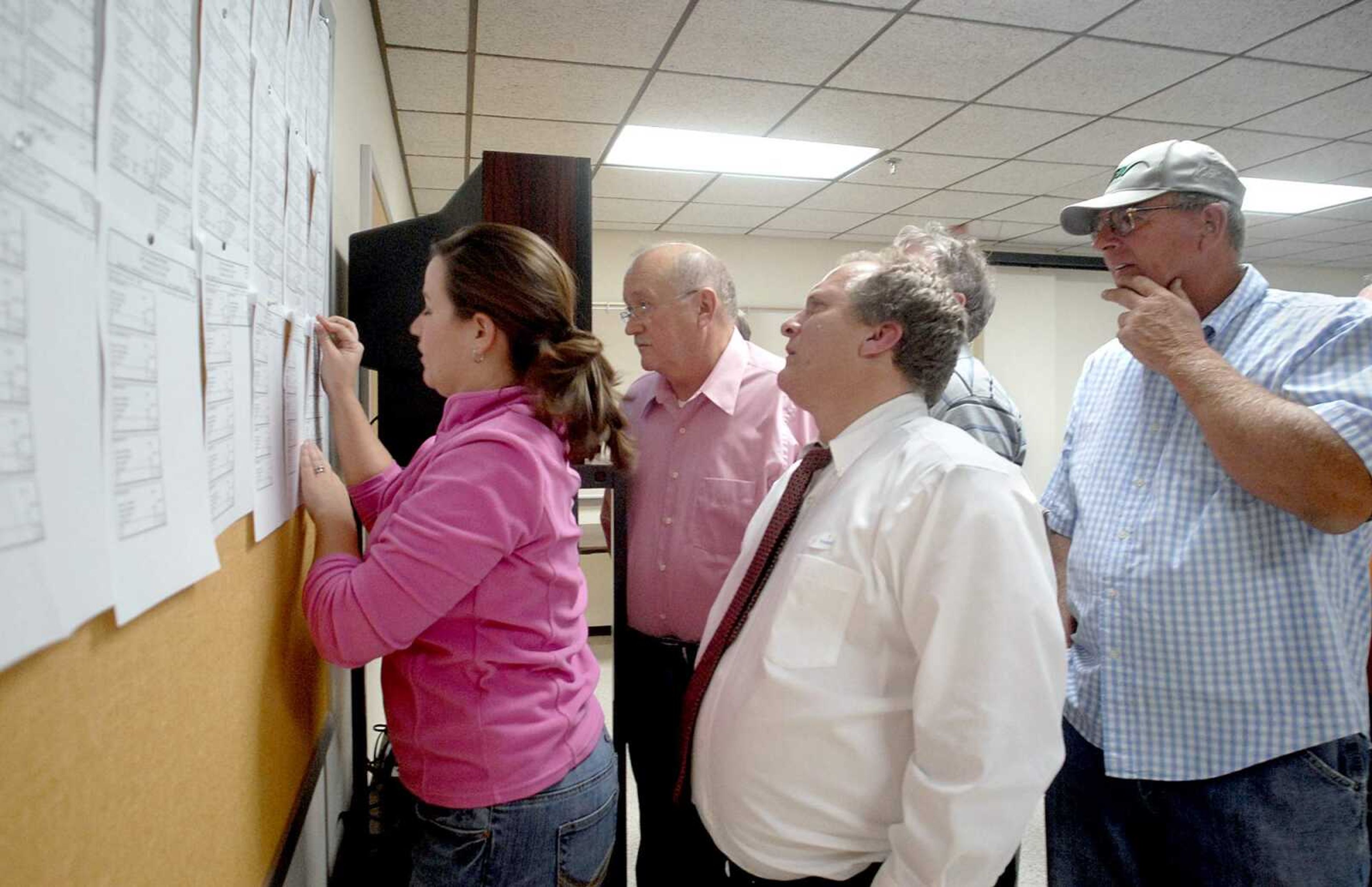 ELIZABETH DODD ~ edodd@semissourian.com
Sarah Keyes, of Cape Girardeau, left, posts more results from the Cape County precincts, while John Clifton, of Cape Girardeau, Scott Reynolds, of Jackson, and Randy Ludwig, of Jackson watches at the Cape County Building Tuesday night.