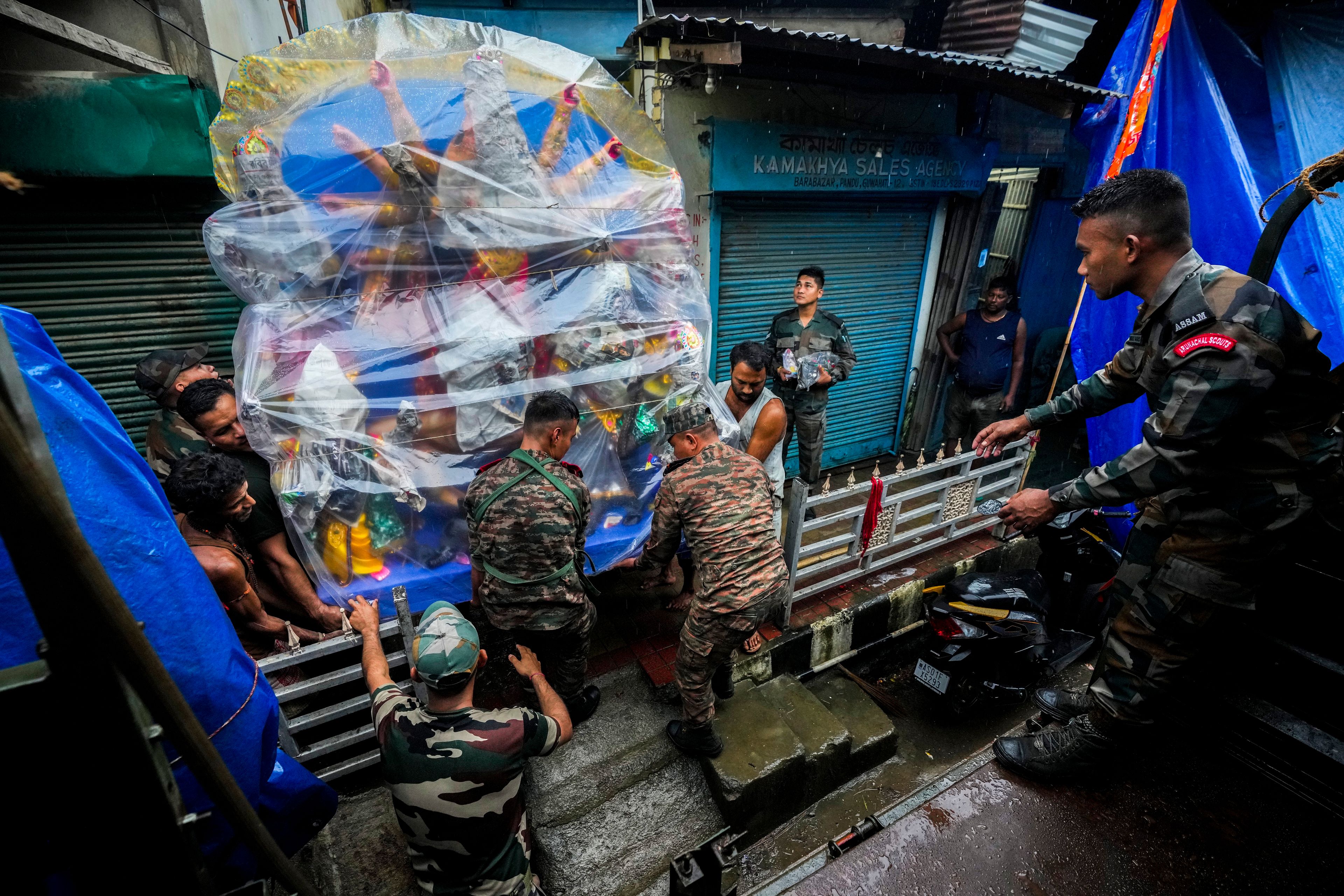 Army personnel from Shillong, in the neighboring state of Meghalaya, collect a mud idol of the Hindu goddess Durga from a workshop ahead of the Durga Puja festival in Guwahati, India, Friday, Oct. 4, 2024. (AP Photo/Anupam Nath)