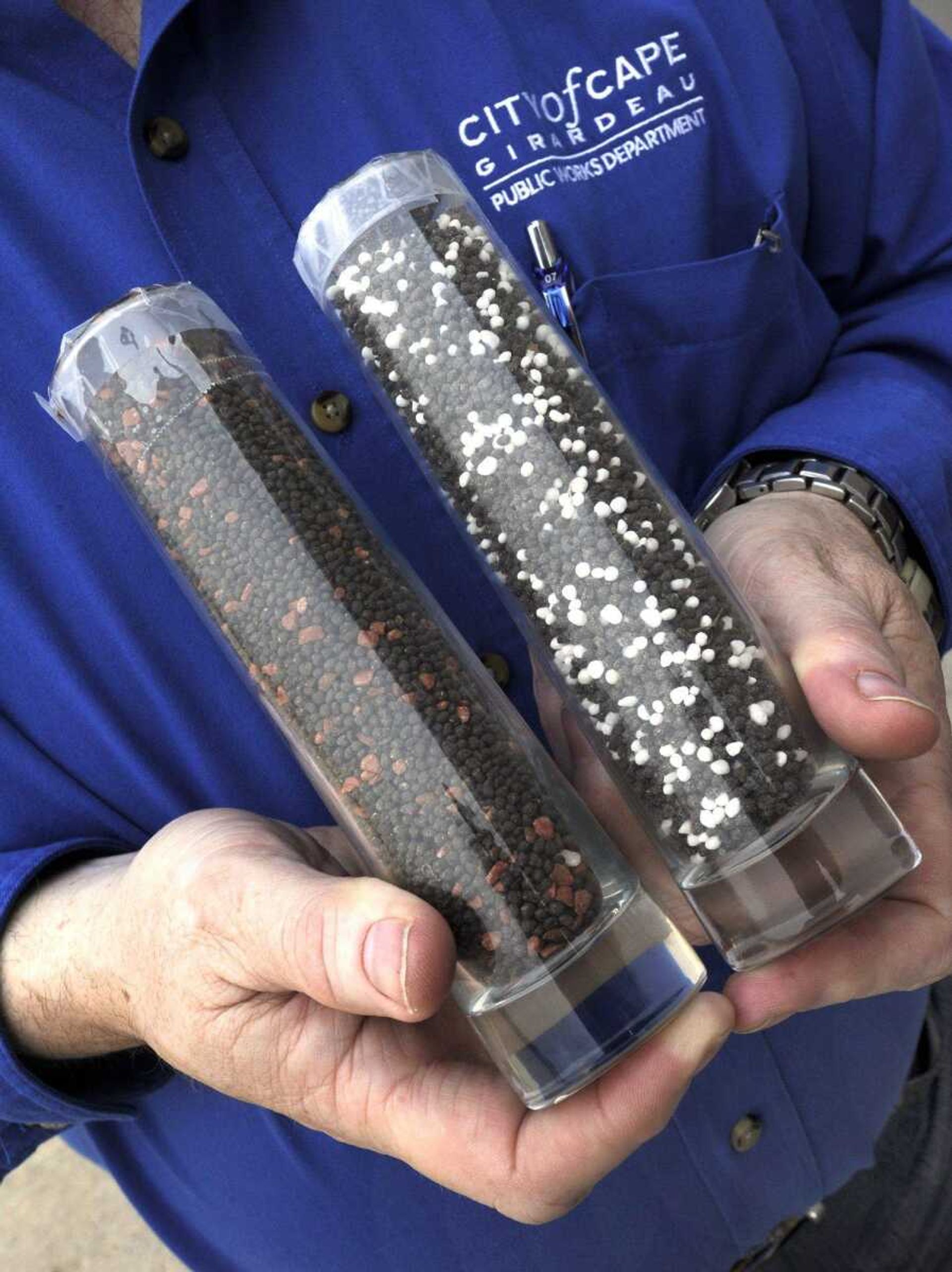 Tim Gramling shows samples of the dried pellets that will be produced by the new wastewater treatment plant, the pellets mixed with potash, left, and mixed with urea to make a fertilizer. (Fred Lynch)