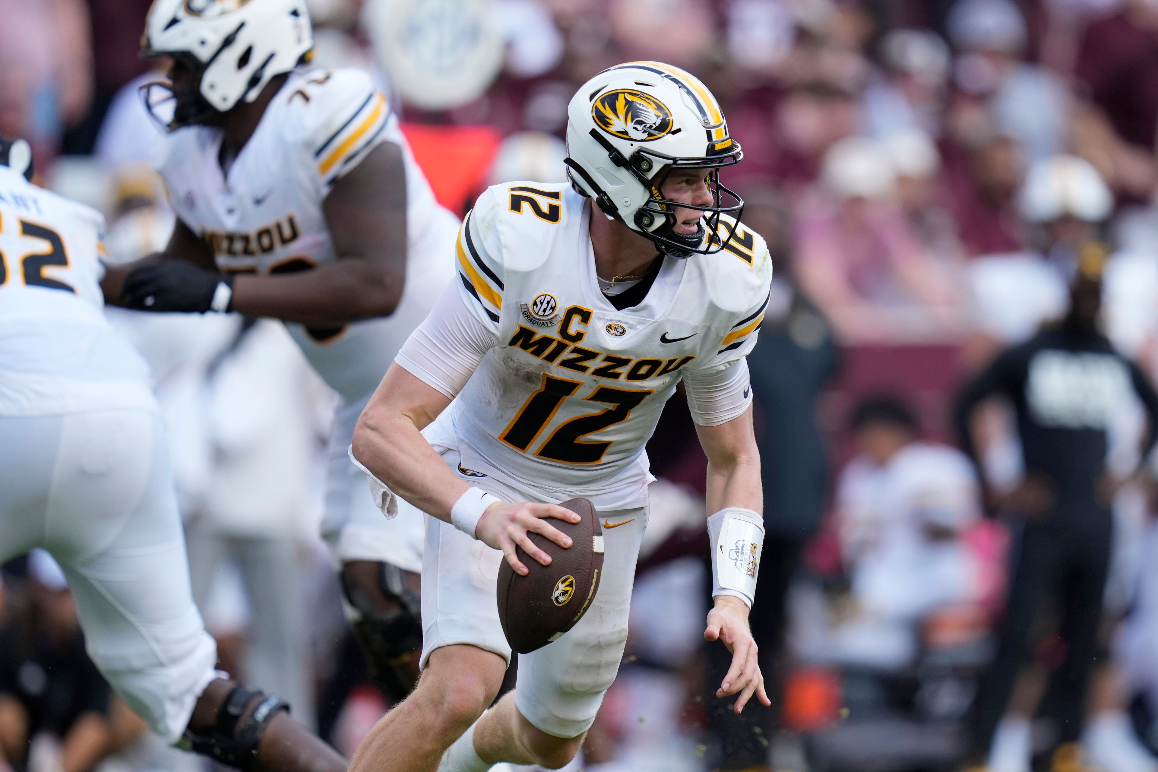 Missouri quarterback Brady Cook (12) scrambles during the second half of an NCAA college football game against Texas A&M Saturday, Oct. 5, 2024, in College Station, Texas. (AP Photo/Eric Gay)