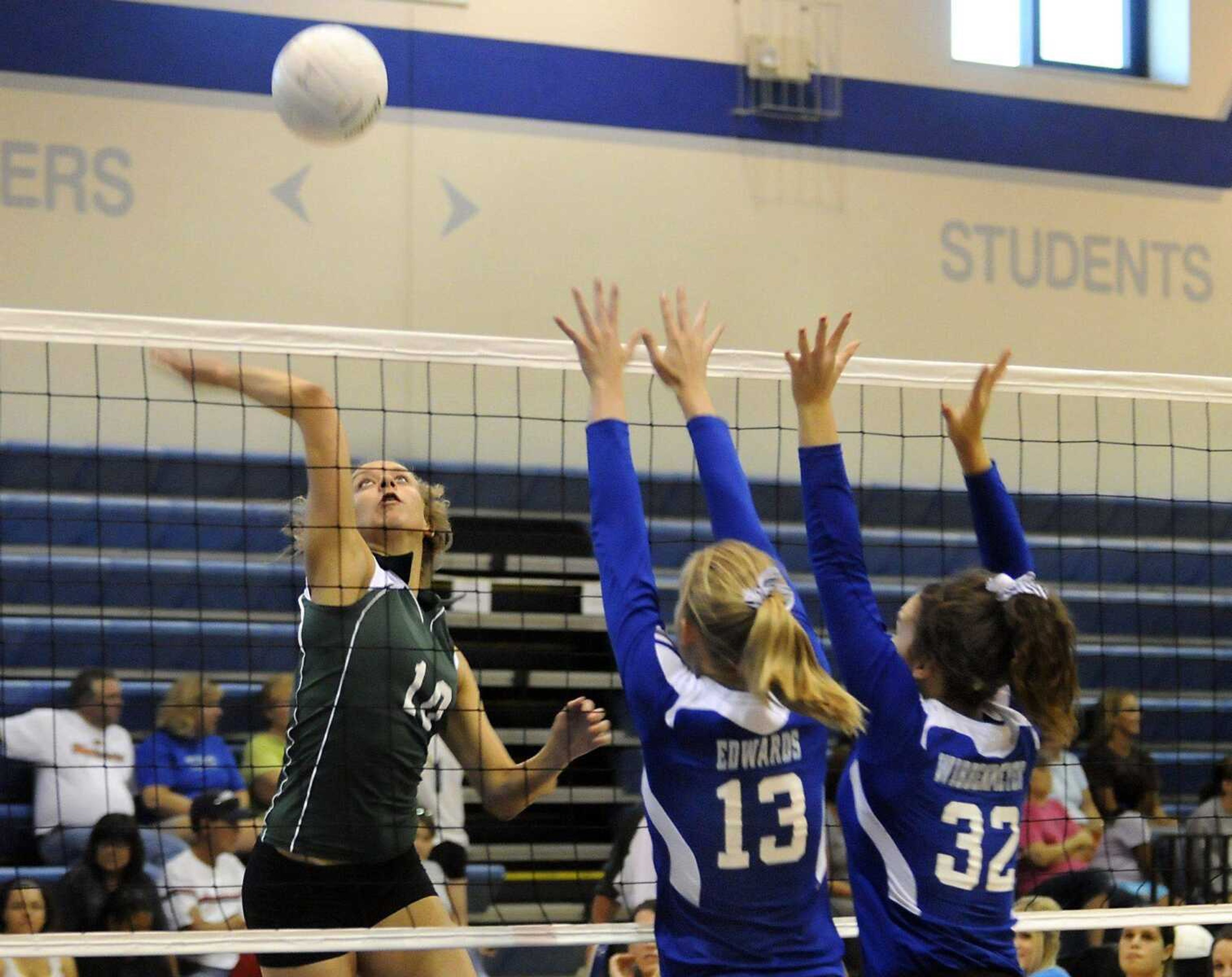 Perryville's Samantha Amberger goes up for a spike as Notre Dame's Kate Edwards and Amy Wibbenmeyer block during the first game of Saturday's title match at Notre Dame VolleyballFest. (KRISTIN EBERTS ~ keberts@semissourian.com)