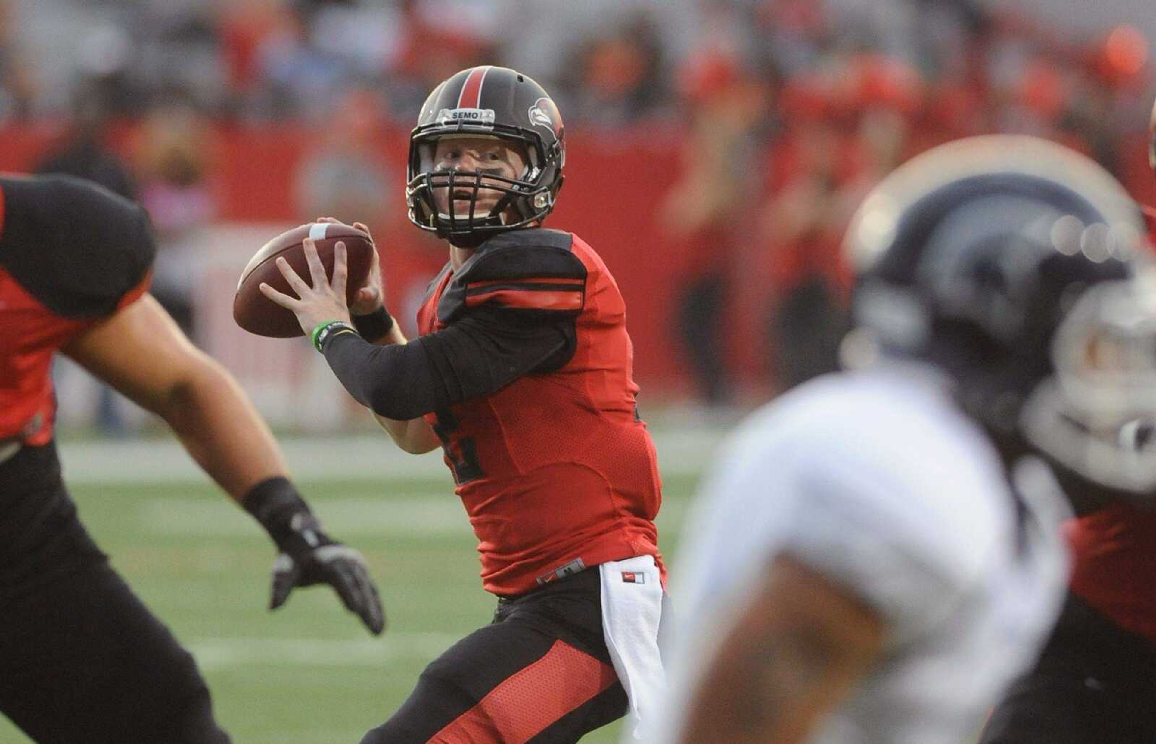 Southeast Missouri State's Kyle Snyder scans for a receiver during the seasons first game against Missouri Baptist Thursday, Aug. 28, 2014 at Houck Stadium. (GLENN LANDBERG)