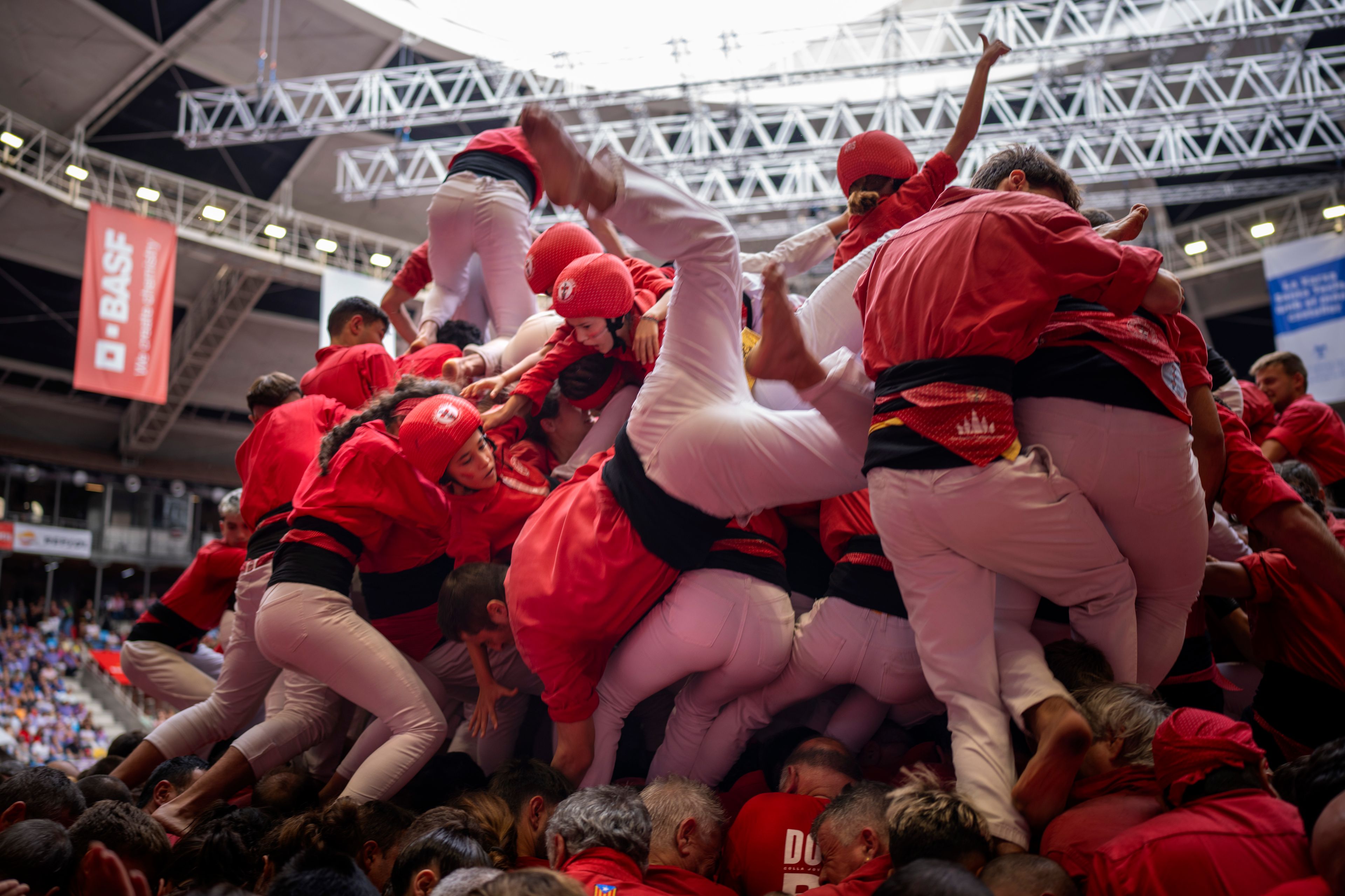 Members of "Colla Joves Xiquets de Valls" fall as they try to form a "Castell" or human tower, during the 29th Human Tower Competition in Tarragona, Spain, Sunday, Oct. 6, 2024. (AP Photo/Emilio Morenatti)