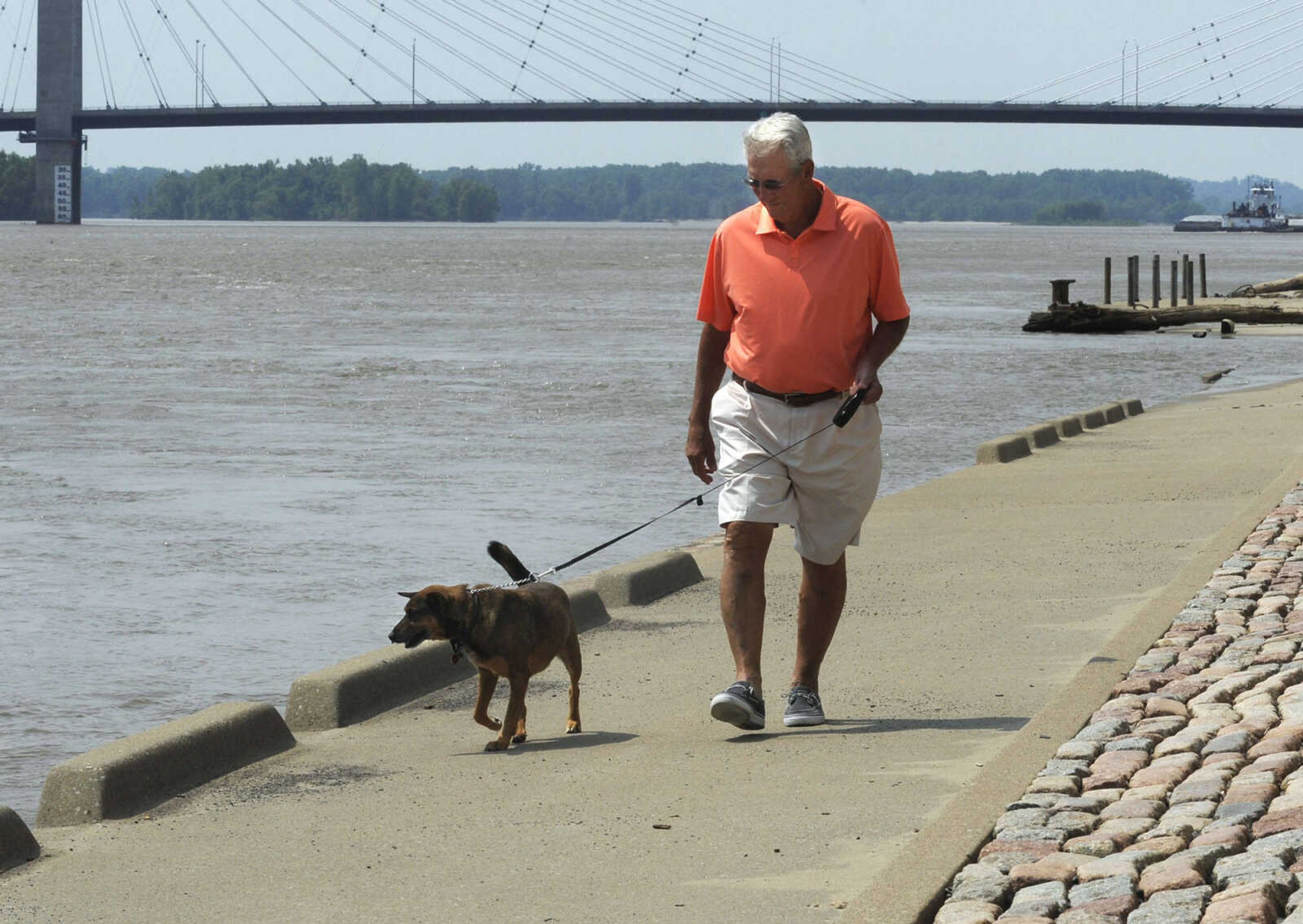 Darold Keller of Murray, Ky. walks his dog, Frank, along the Cape Girardeau riverfront on Sunday, June 13, 2013.