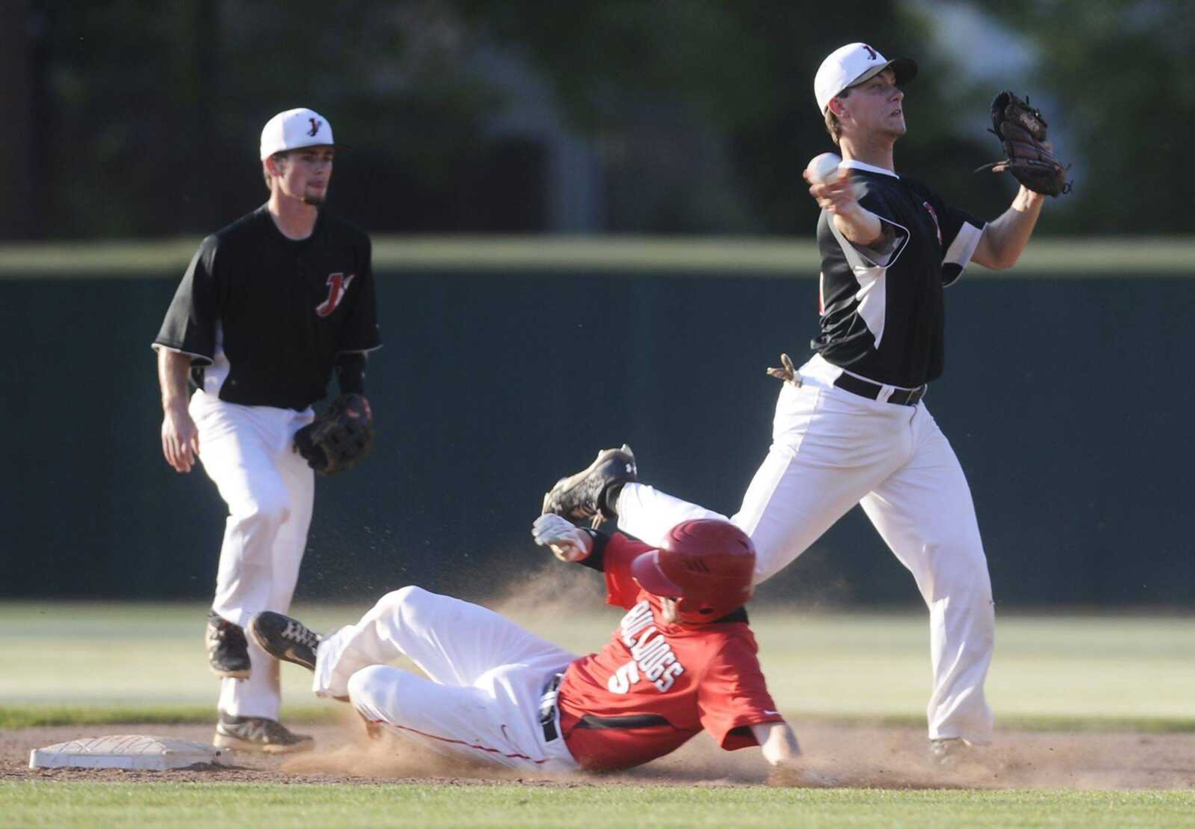 ADAM VOGLER
Jackson's Laban Petzoldt throws to first base to complete the double play as Sikeston's Cord Sheehy tries to break up the play during the second inning in the semifinals of the SEMO Conference baseball tournament Tuesday at Capaha Field. Jackson won 2-1 to reach the final.