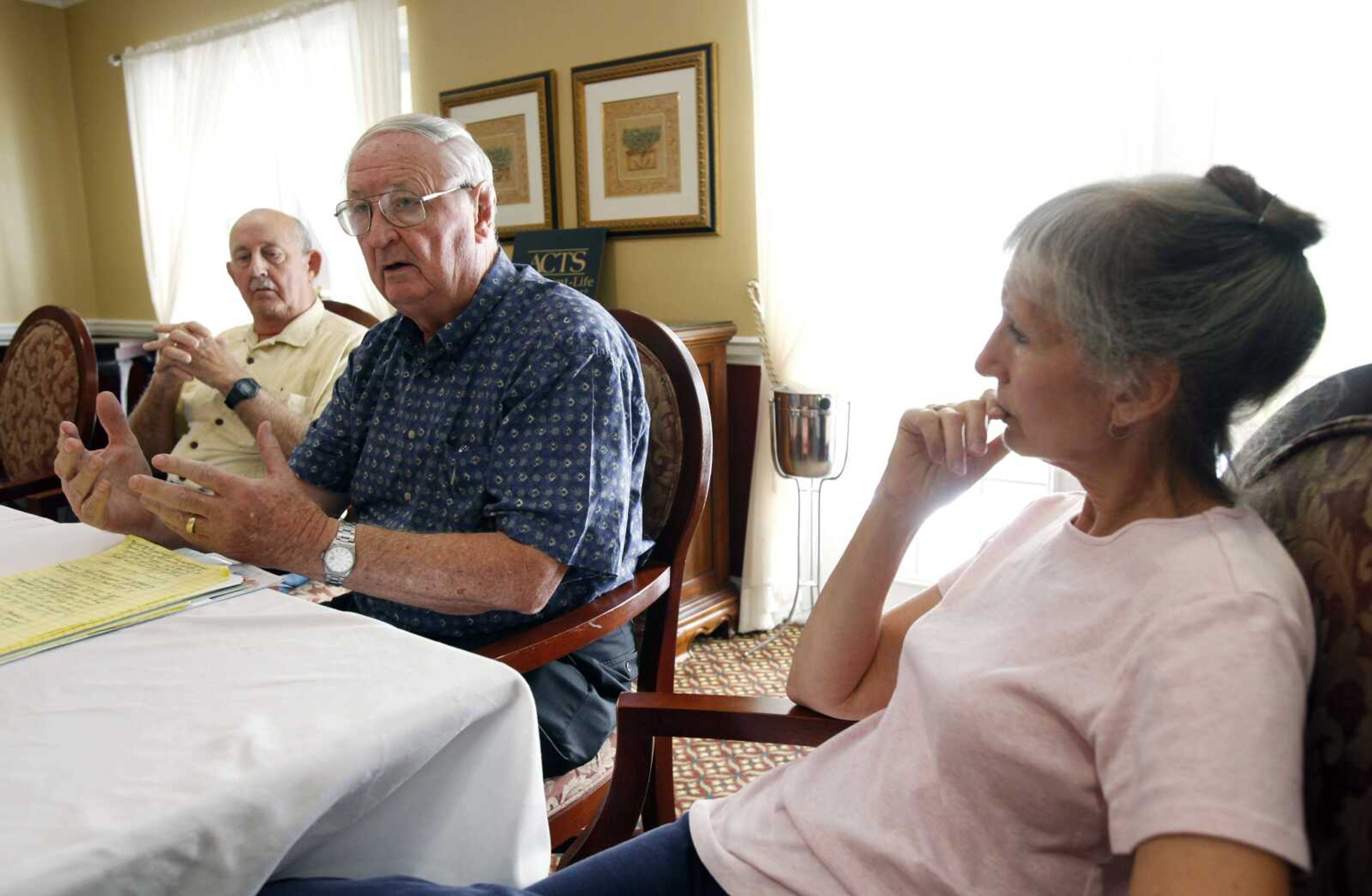 Jack Dawson, center, gestures as he speaks during an interview as Everett Rawlings, left, and Bette Baldwin, right, look on Monday at the St. Andrews Estates North retirement community in Boca Raton, Fla. (Wilfredo Lee ~ Associated Press)