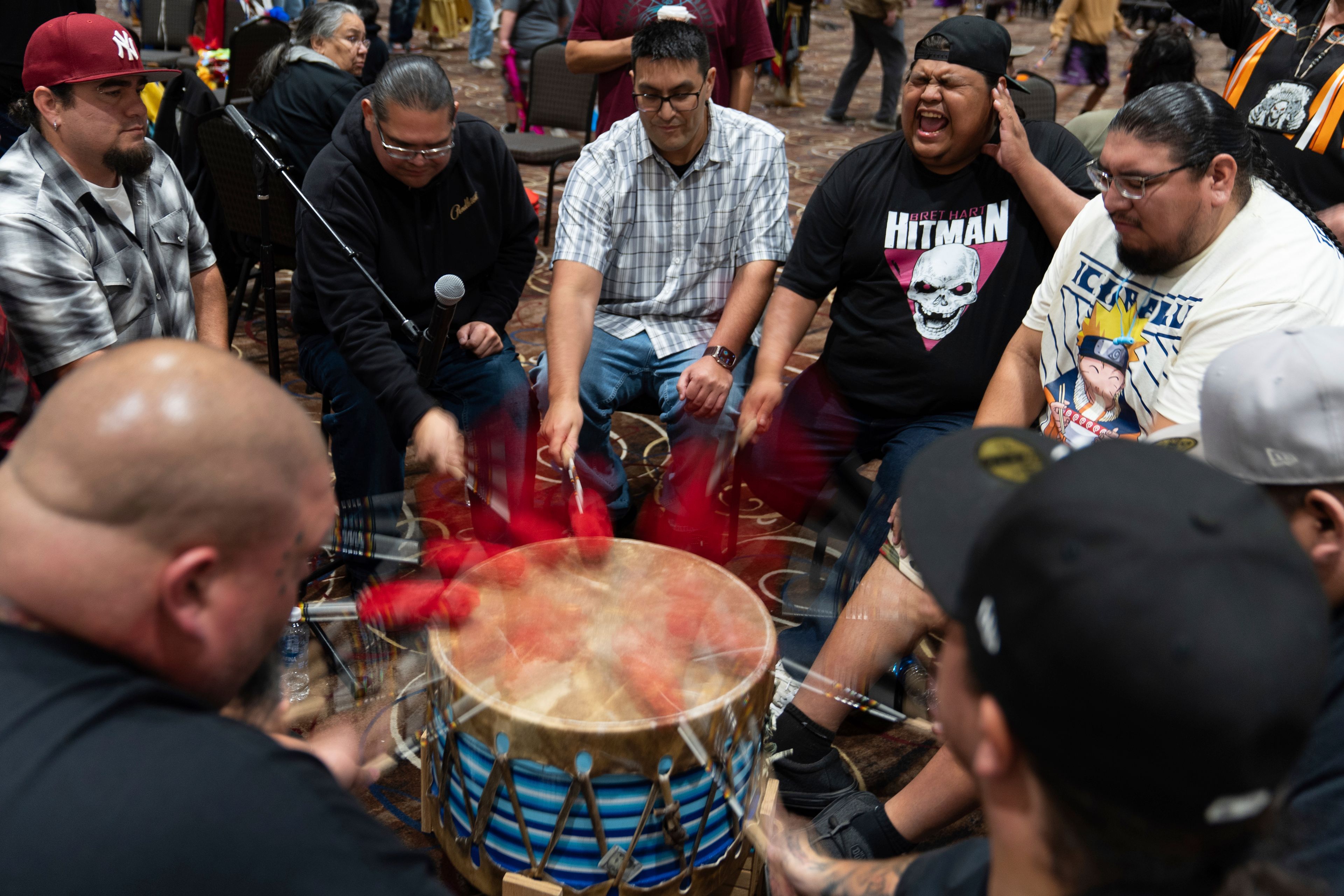 Members of the Warrior Society drum group, clockwise from bottom left, Taylor Hawk, Jimmy Williams, J.J. Jackson, Lawney Havranek, George Clements, Henry Rondeau, Plummie Wright, and Ron Butler, perform during a powwow at Chinook Winds Casino Resort, Saturday, Nov. 16, 2024, in Lincoln City, Ore. (AP Photo/Jenny Kane)