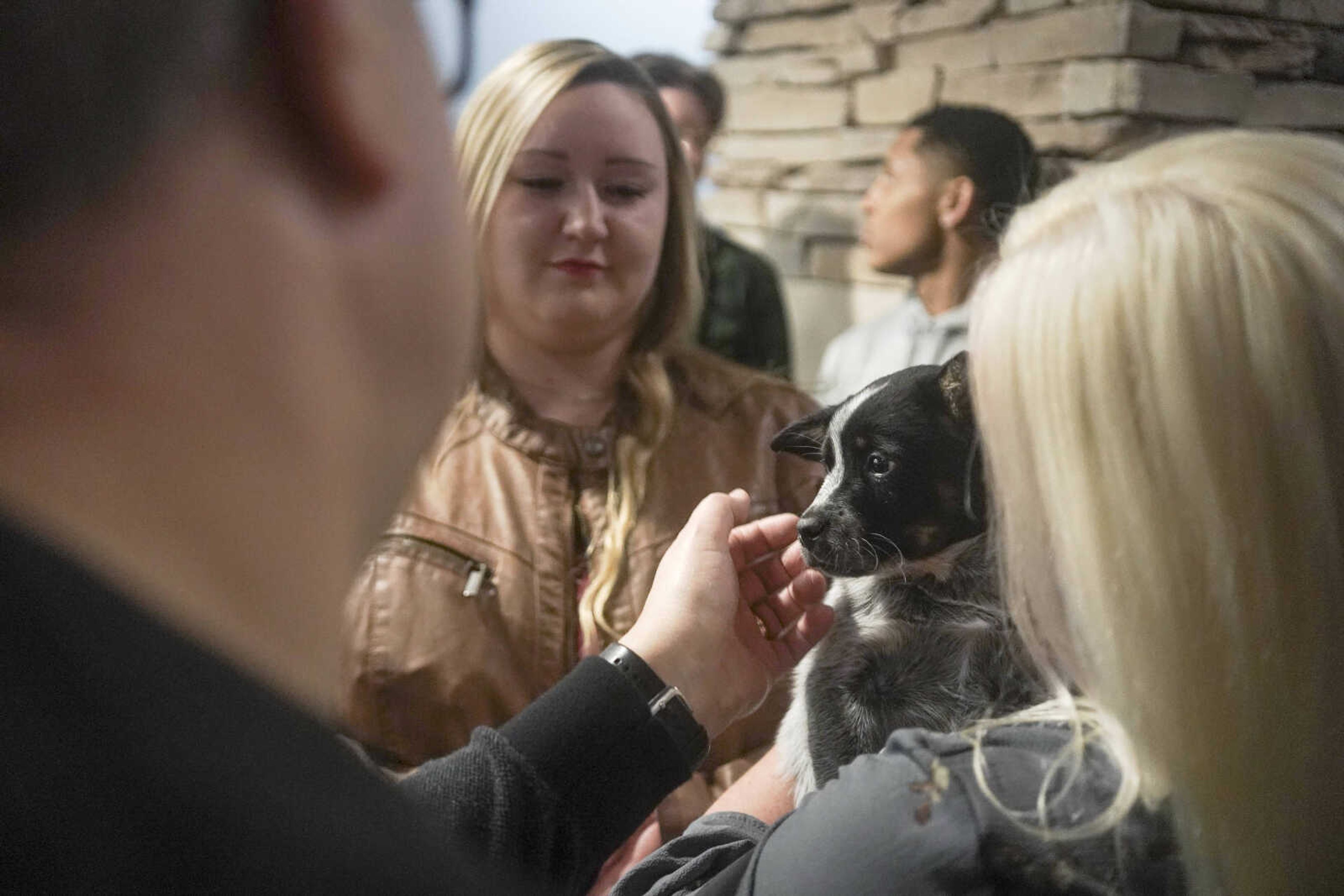 Roy Merideth, left, pets a puppy held by Angela Hubbard, right, during the Humane Society of Southeast Missouri Power of Pawsitivity fundraiser Saturday, Feb. 29, 2020, at the Jackson Civic Center in Jackson.