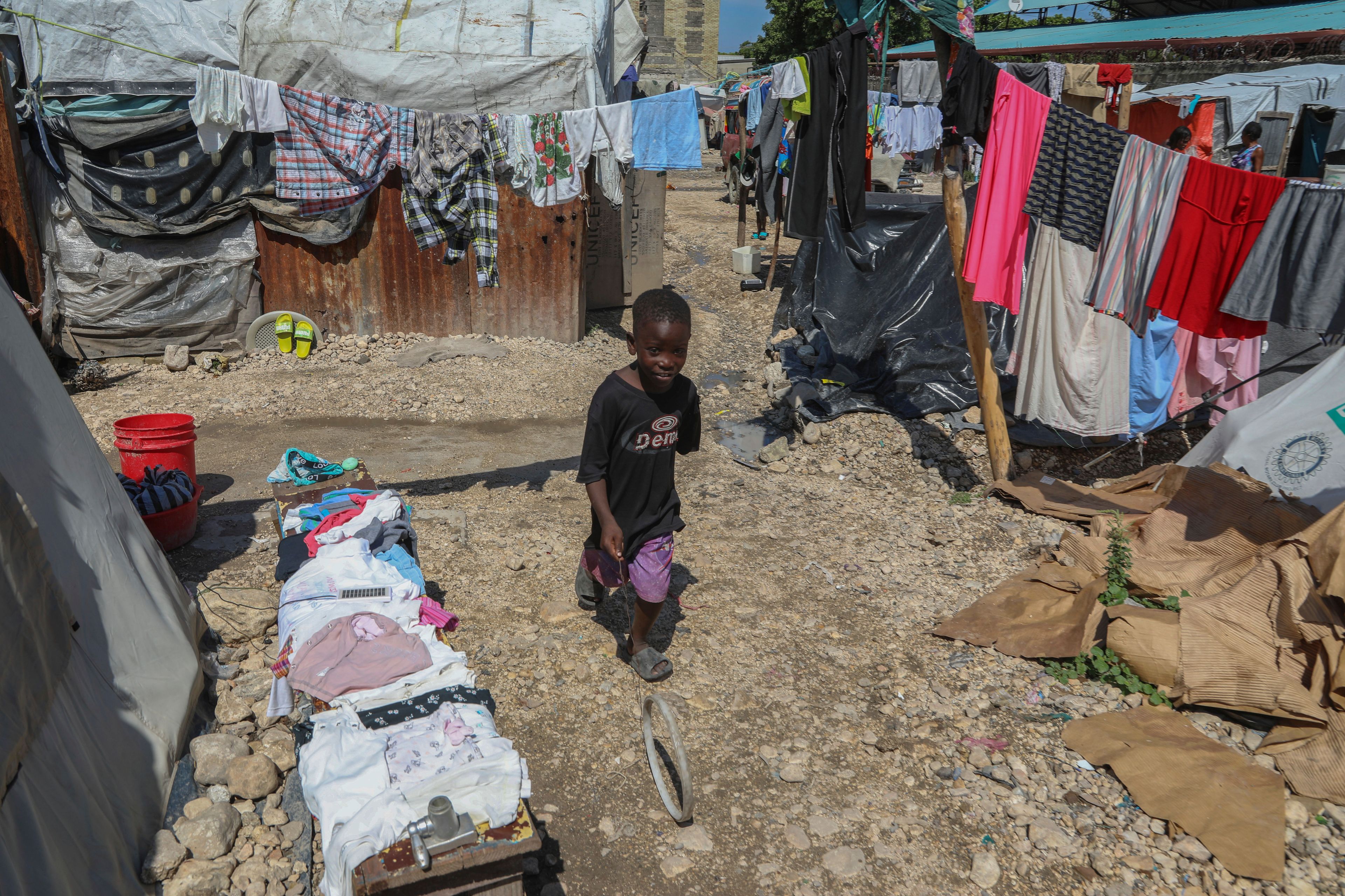 A youth plays with a ring at the end of a wire inside a school where people displaced by gang violence have taken refuge for over a year in Port-au-Prince, Haiti, Friday, Sept. 20, 2024. (AP Photo/Odelyn Joseph)