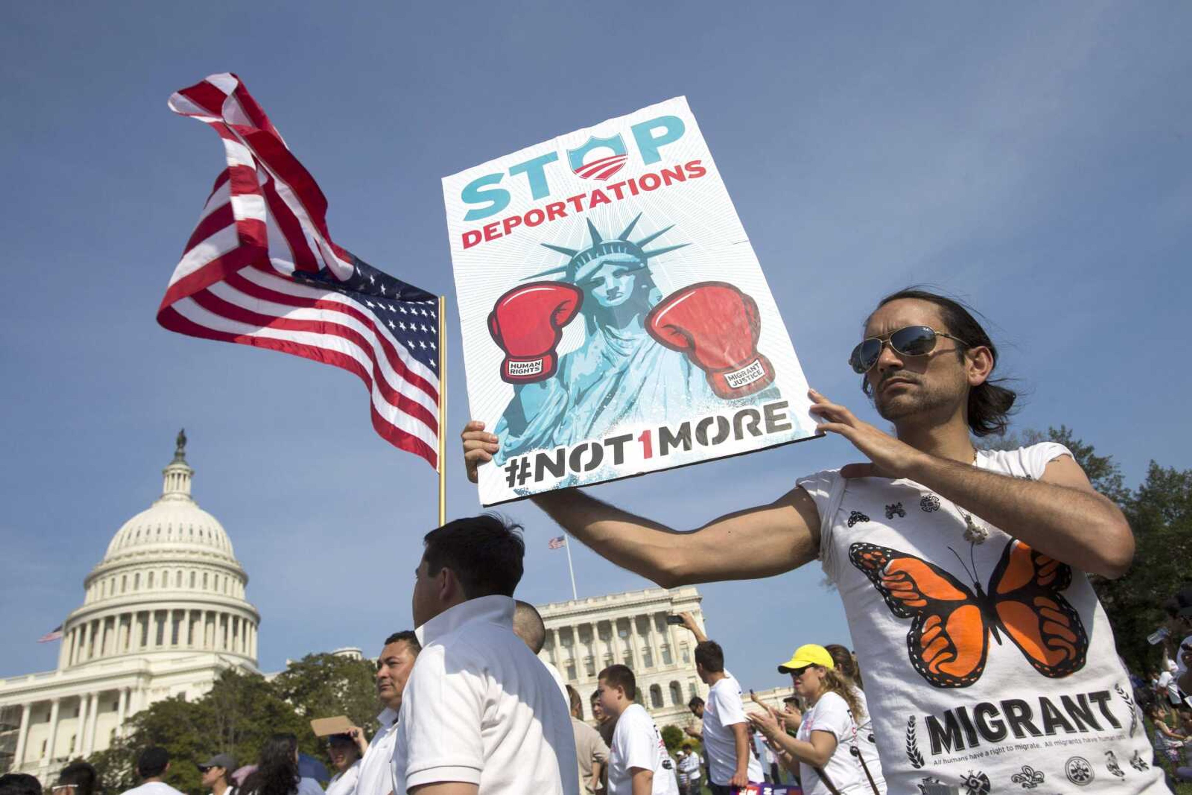 Cesar Maxit, of Washington, who is originally from Argentina, hold a sign that says "Stop Deportations" at the Rally for Citizenship, a rally in support of immigration reform, on Capitol Hill in Washington, on Wednesday, April 10, 2013. Bipartisan groups in the House and Senate are said to be completing immigration bills that include a pathway to citizenship for the nation's 11 million immigrants with illegal status. (AP Photo/Jacquelyn Martin)