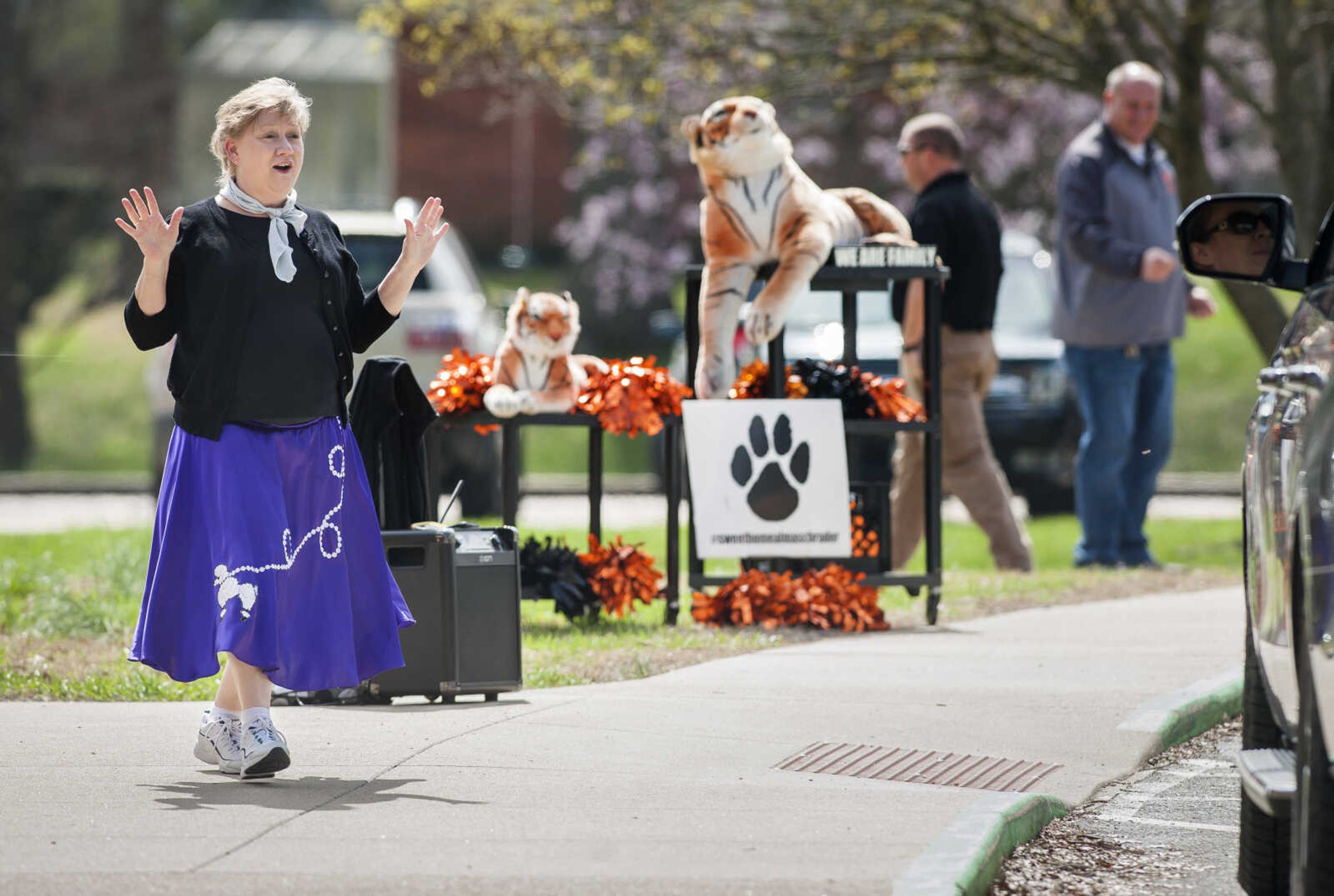 Alma Schrader Elementary School teacher Rebecca Gentry waves to students and parents as they arrive for lunch pick-ups Wednesday, March 25, 2020, while 50's music plays in honor of Alma Schrader Day, which celebrates the school's opening in 1959 in Cape Girardeau.