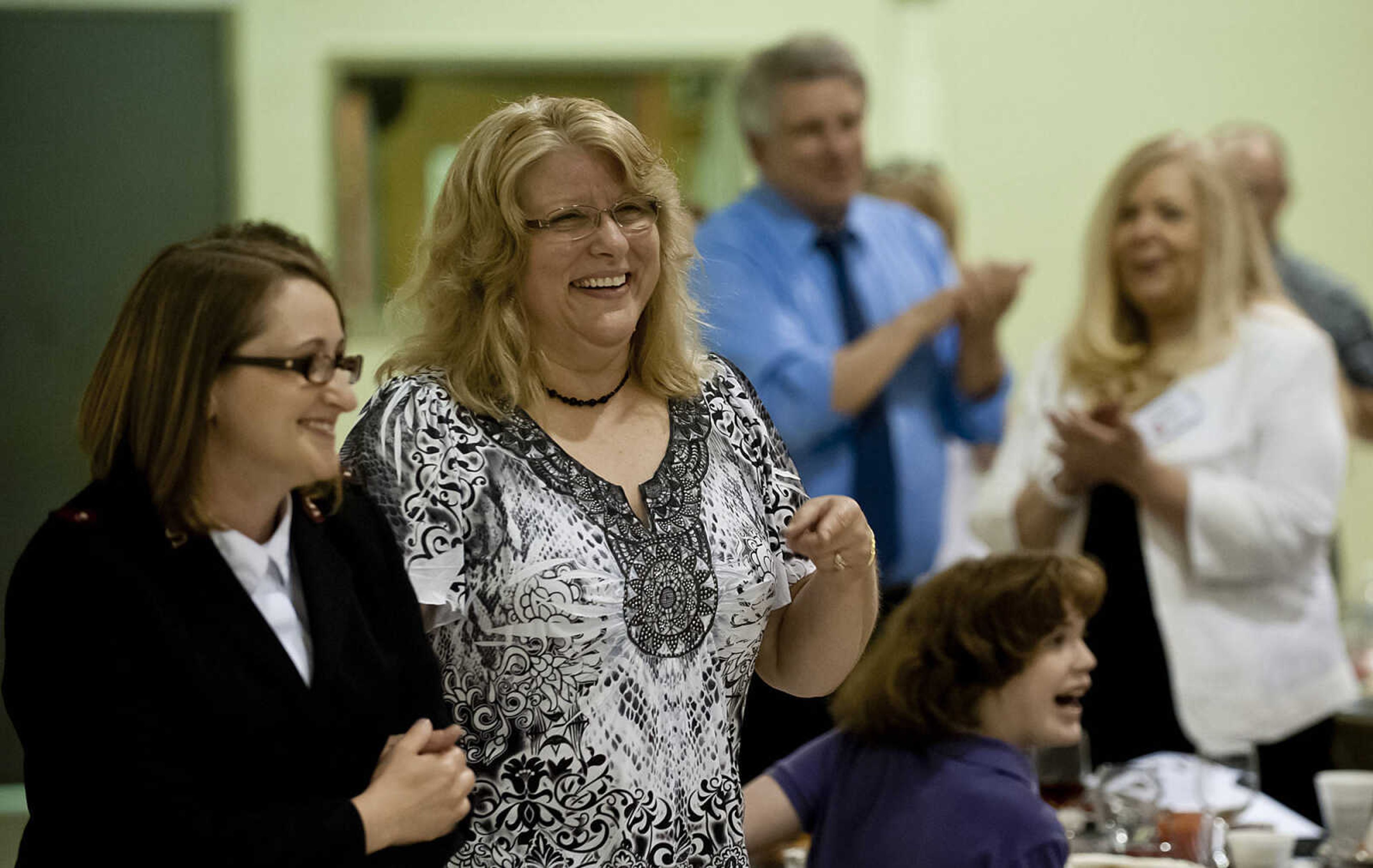 Capt. Bridgette Amick walks case worker Tina Rodgers to the front after Rodgers was named the recipient of the Star Light Award during the Cape Girardeau Salvation Army's annual dinner, "A Night with the Stars," Thursday, May 8, at the Cape Girardeau Salvation Army.