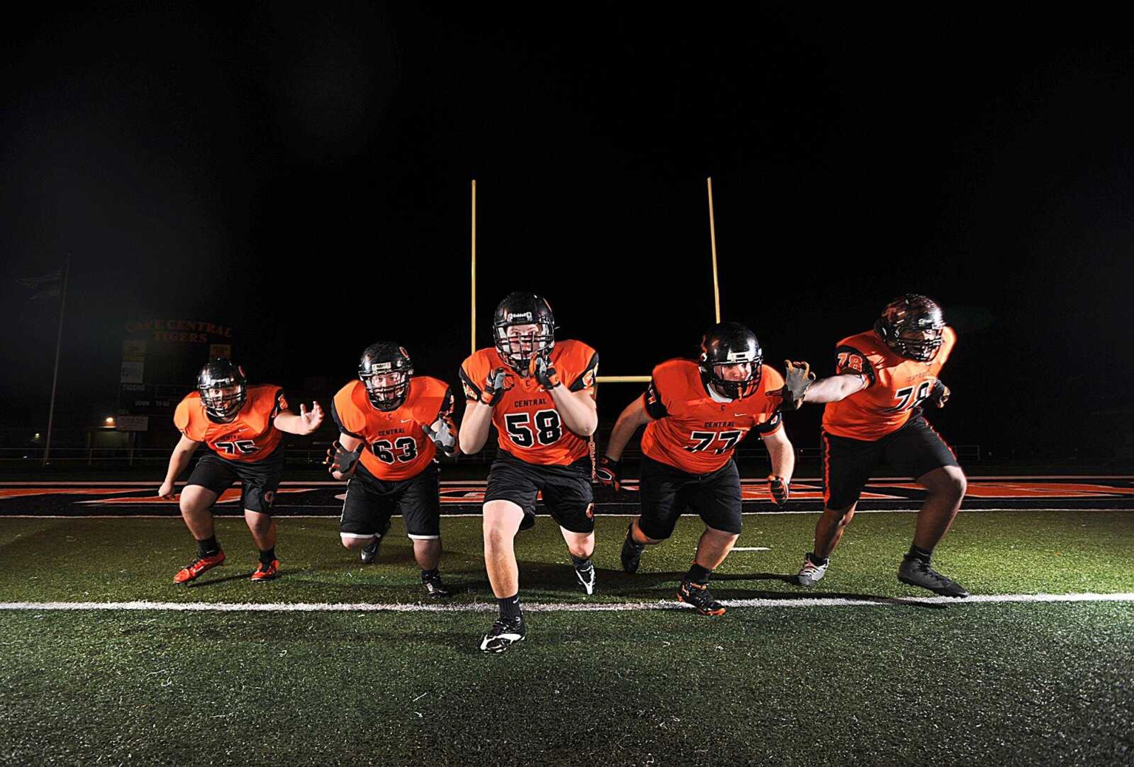 Cape Central's offensive line from left, Jon Long, Jacob Holter, Max Abbott, Casey Vaughn and Jaylen Flye-Sadler, pose for a photo at Tiger Stadium, Monday, Nov. 24, 2014. (Laura Simon)