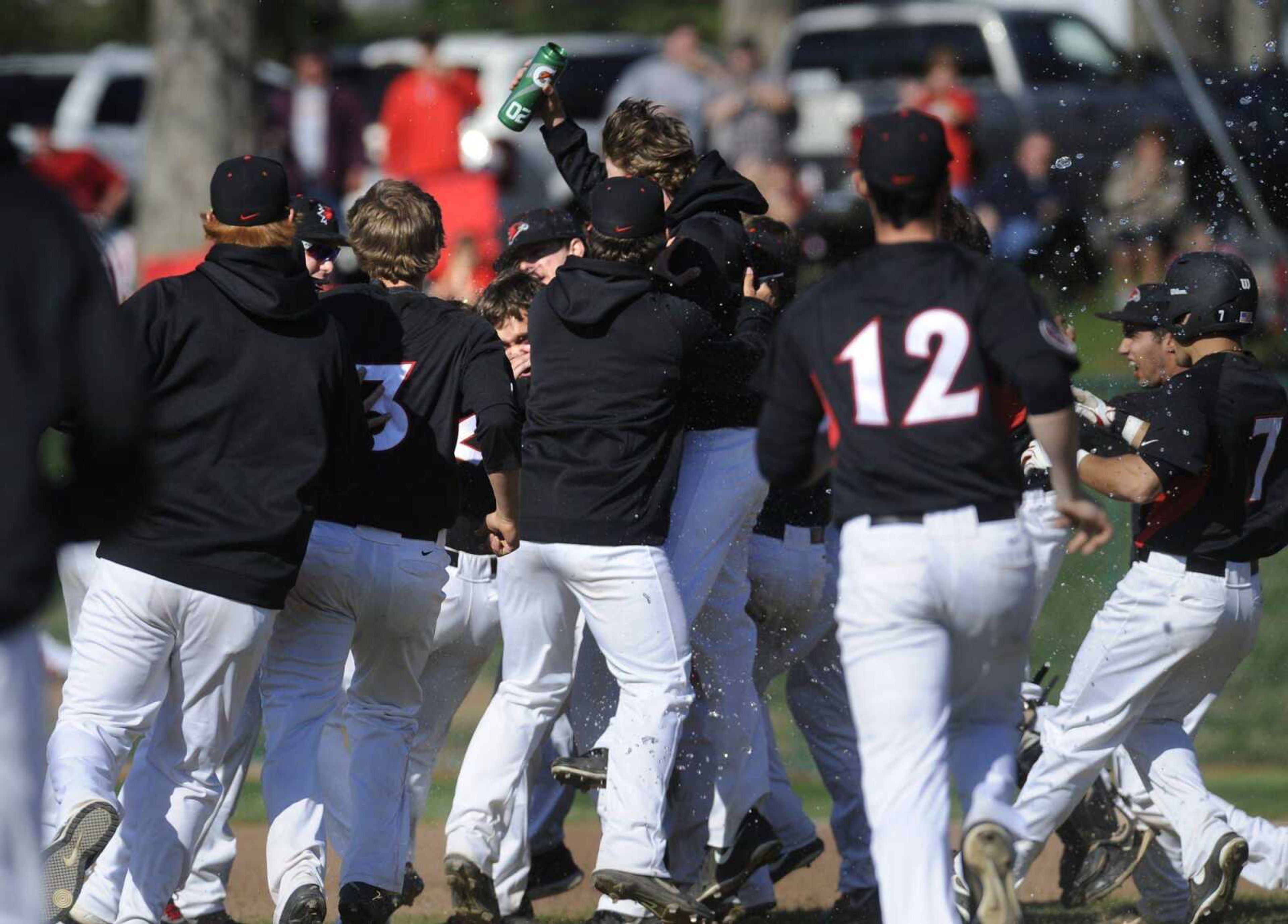 The Redhawks celebrate as they run out onto the field to surround Andy Lennington after his walk-off hit to win 8-7 over the SIUE Cougars on Saturday, April 5, 2014 at Capaha Field. (Fred Lynch)