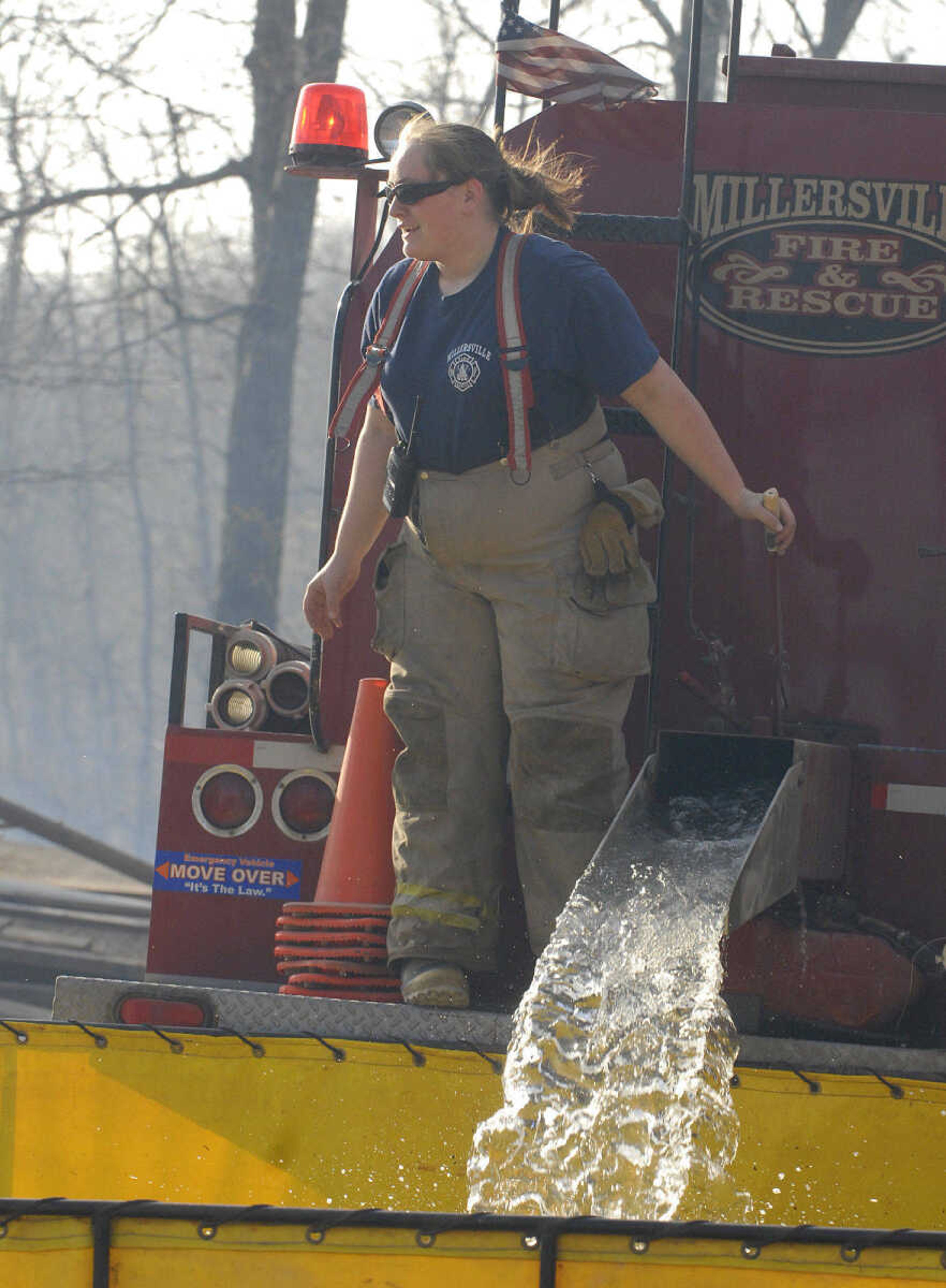 LAURA SIMON~lsimon@semissourian.com
A Millersville firefighter refills a holding tank during a natural cover fire off of Cissus Lane near Neelys Landing Sunday, April 3, 2011. Firefighters from Cape Girardeau, Perry, Scott, and Bollinger Counties contained the blaze that ravaged 50 acres of land.