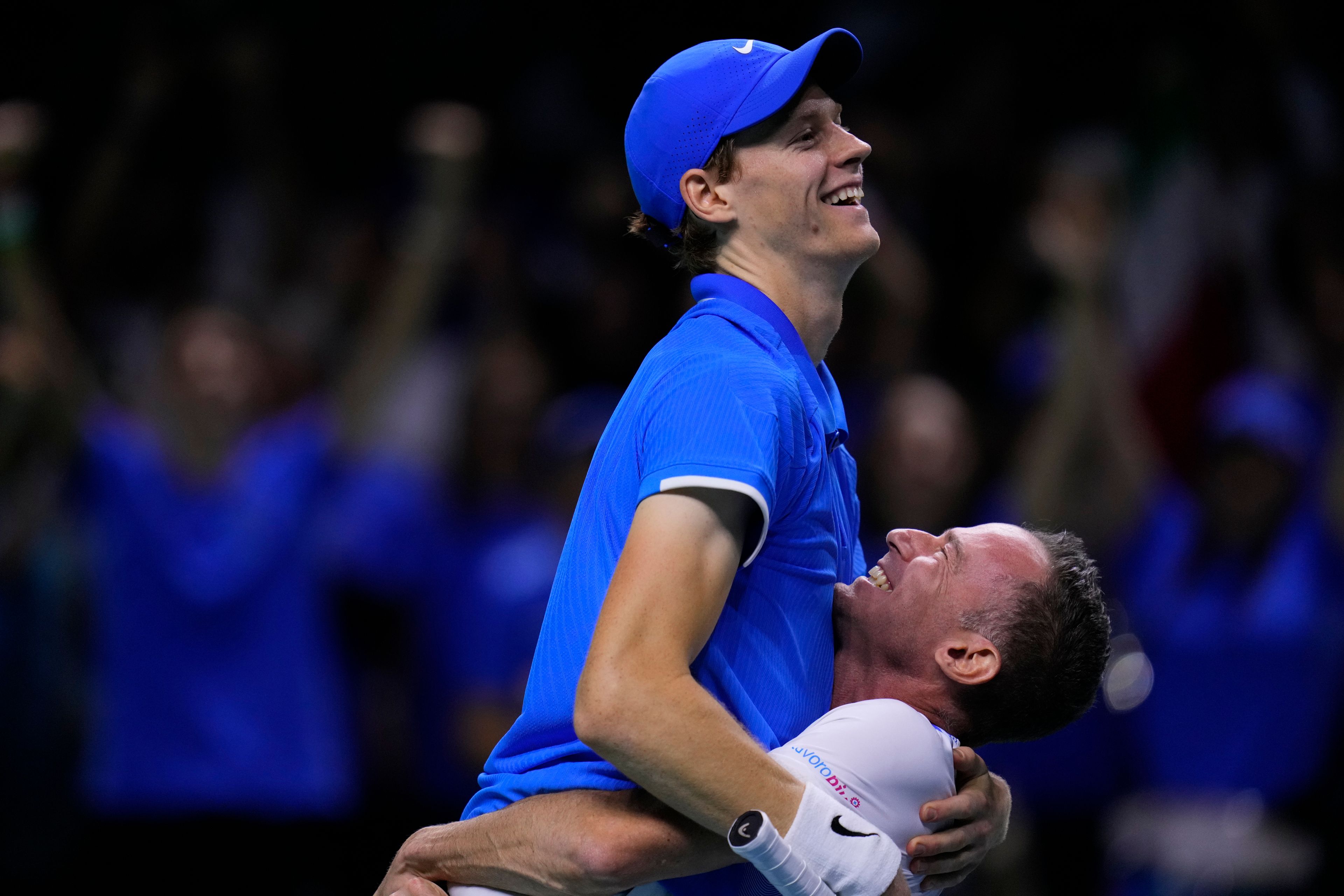 Italy's Jannik Sinner celebrates with team captain Filippo Volandri as he defeats Netherlands' Tallon Griekspoor during the Davis Cup final tennis match between Netherlands and Italy at the Martin Carpena Sports Hall in Malaga, southern Spain, Sunday, Nov. 24, 2024. (AP Photo/Manu Fernandez)