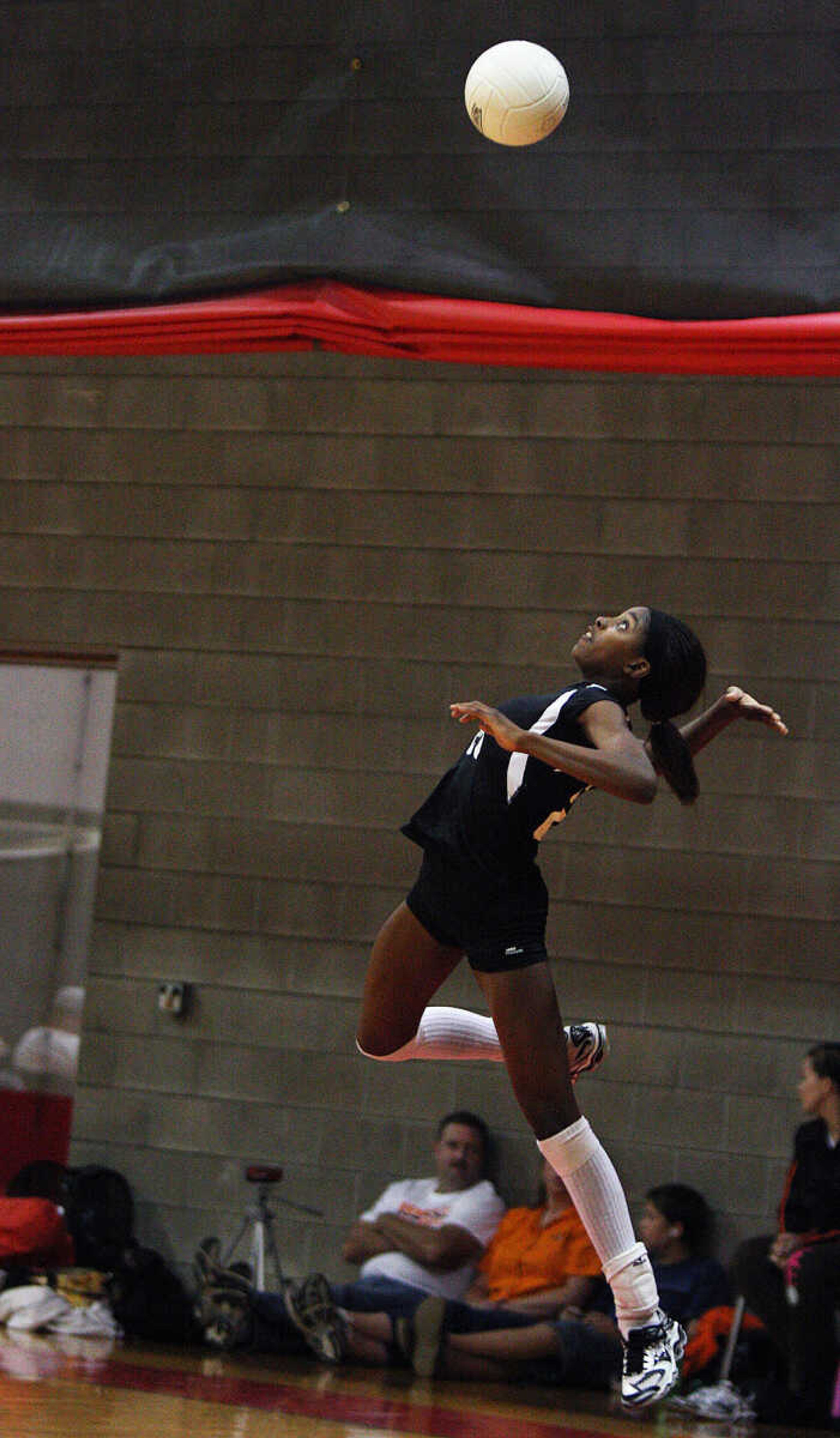 Bell City's Jasmine Johnson leaps high during her serve against Cape Central.