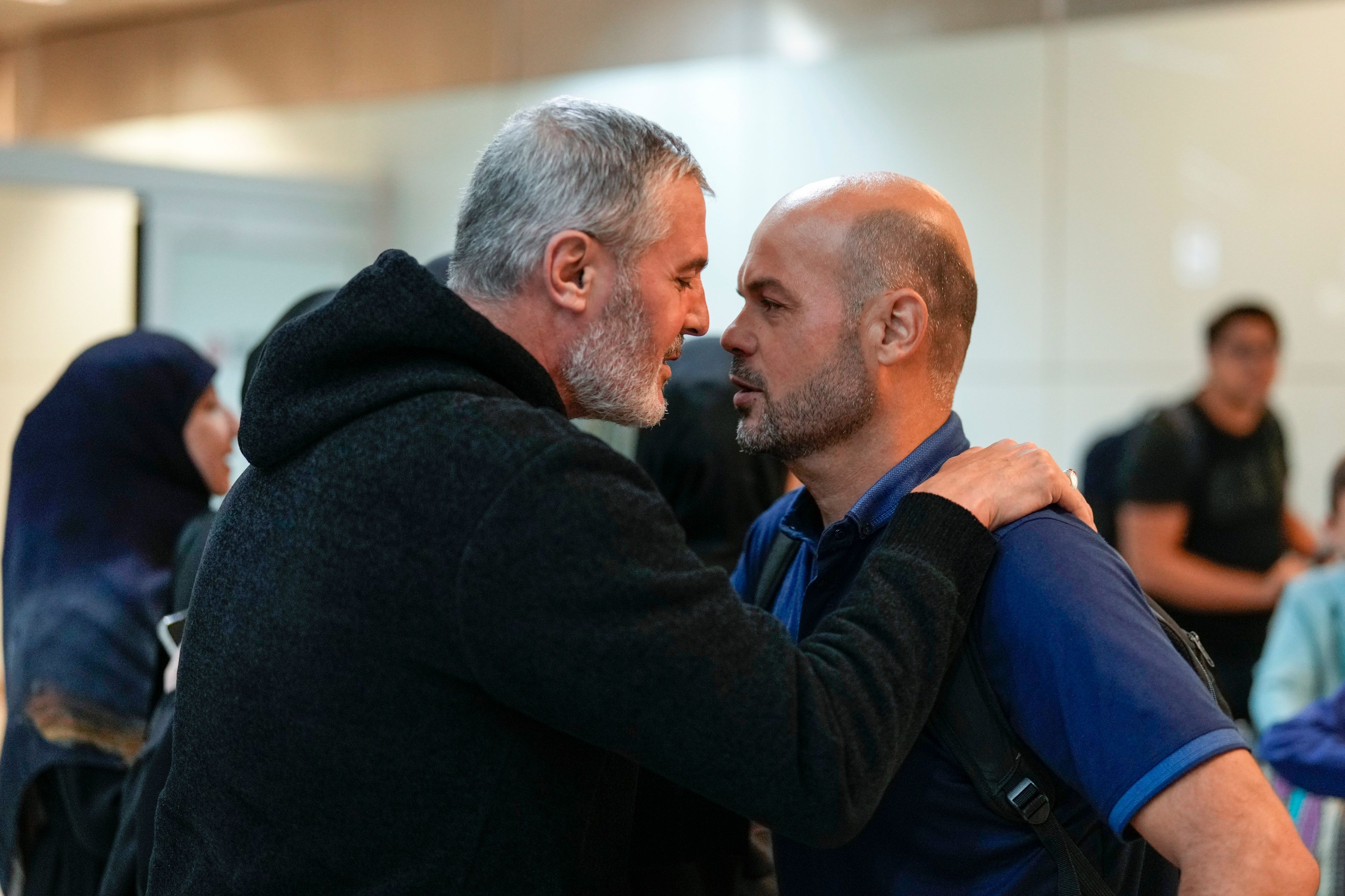 Lebanese citizen Ali Zeineddine, left, greets his brother Hussein arriving from Lebanon, after an Israeli air strike killed various members of their family, at Sao Paulo International airport, Thursday, Oct. 3, 2024. (AP Photo/Andre Penner)