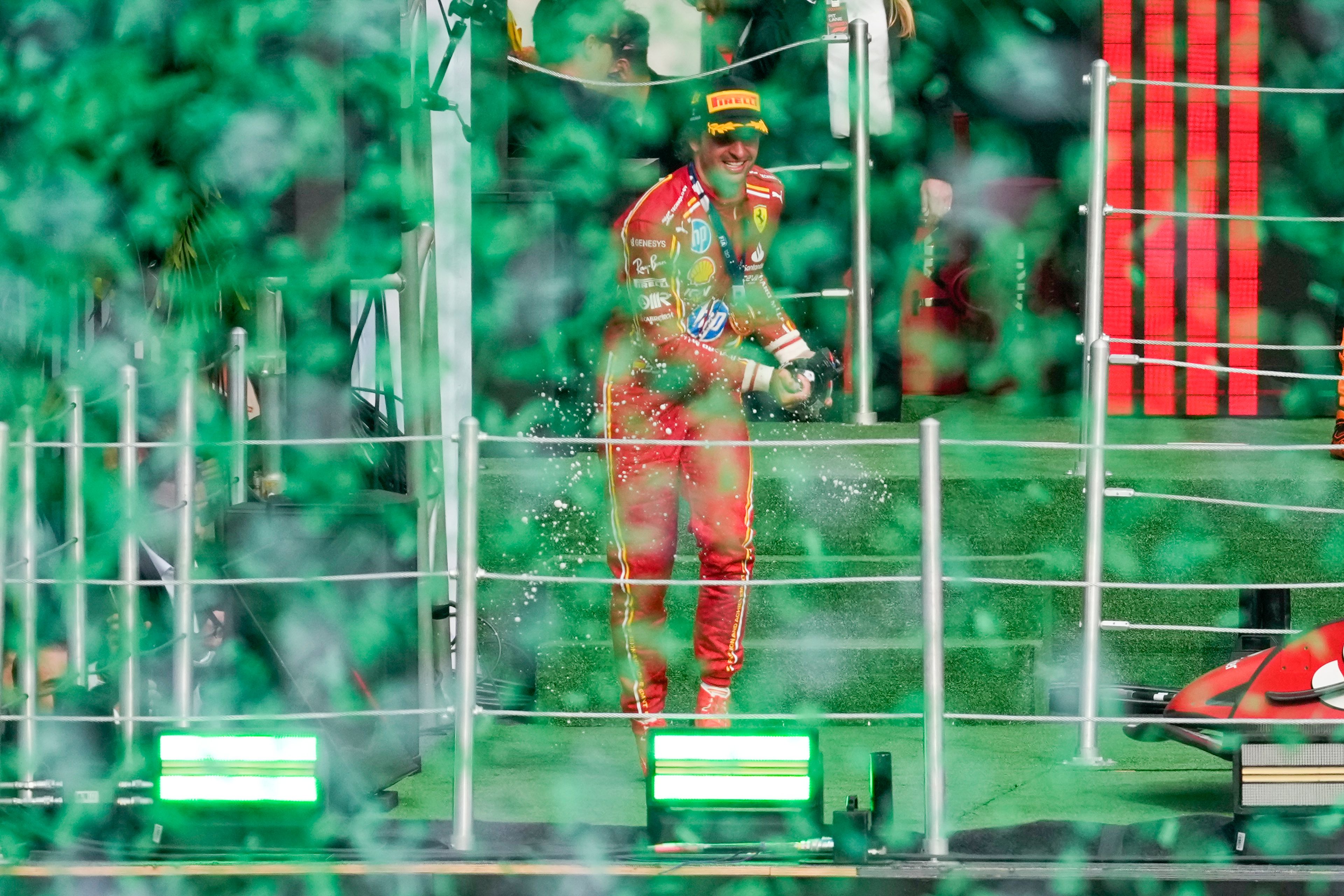 Ferrari driver Carlos Sainz of Spain celebrates after winning the Formula One Mexico Grand Prix auto race at the Hermanos Rodriguez racetrack in Mexico City, Sunday, Oct. 27, 2024. (AP Photo/Eduardo Verdugo)