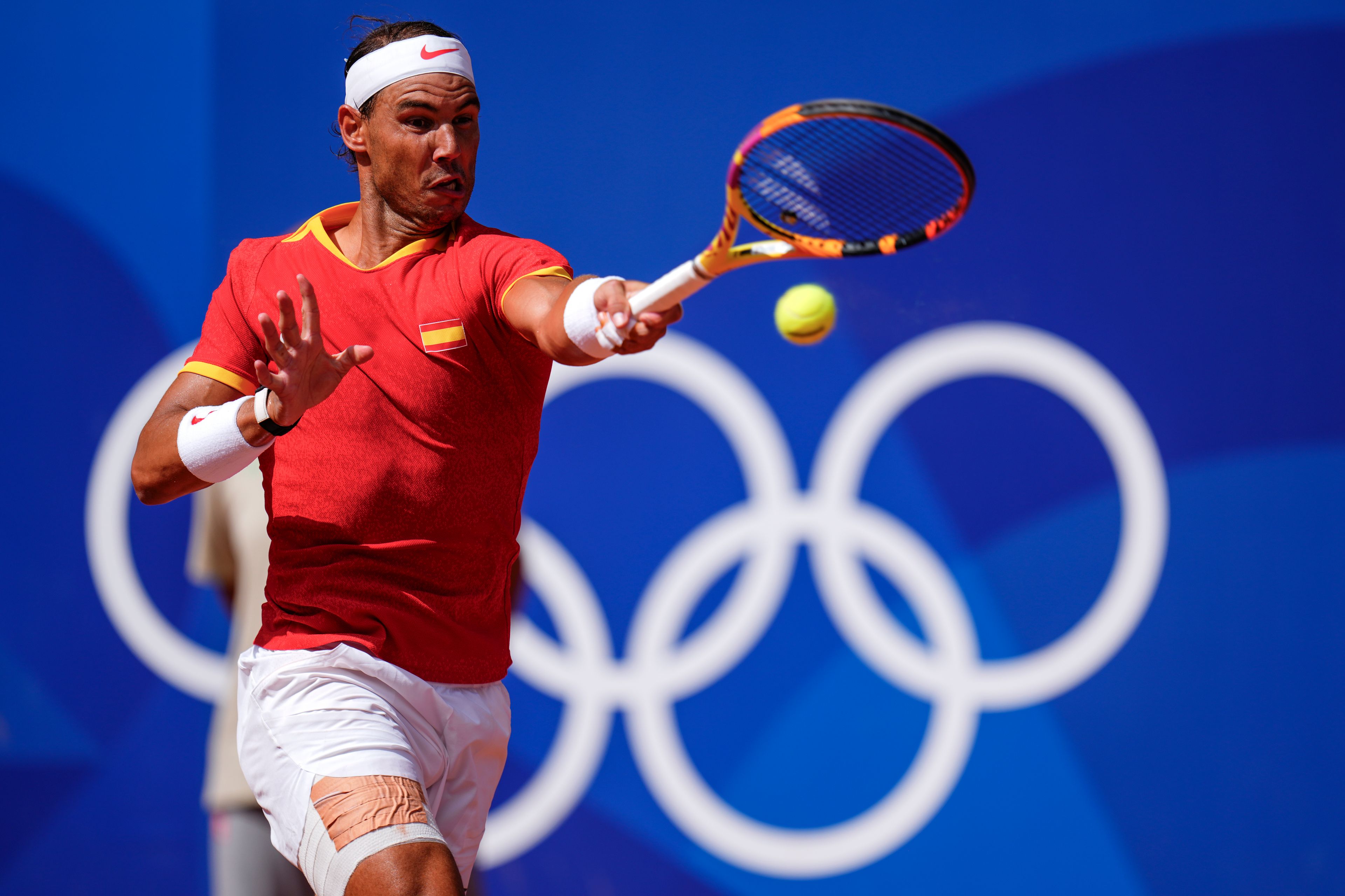 FILE - Rafael Nadal of Spain returns the ball against Marton Fucsovics of Hungary during the men's singles tennis competition, at the 2024 Summer Olympics, Sunday, July 28, 2024, in Paris, France. (AP Photo/Manu Fernandez, File)