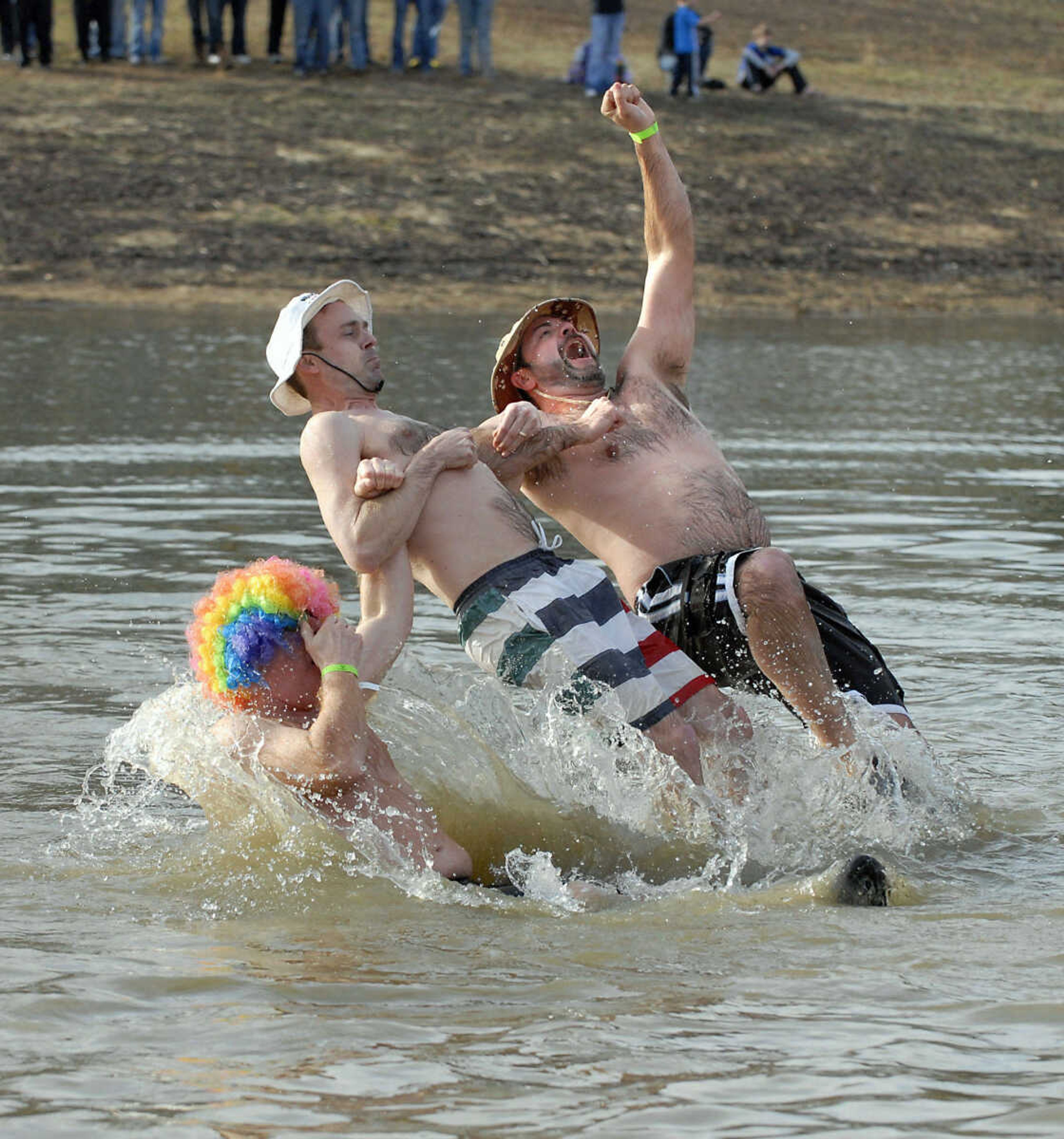 KRISTIN EBERTS ~ keberts@semissourian.com

From left, Kevin Albrecht, Brian Stith and Greg Combs link arms as they dive backwards into the water during the 2012 Polar Plunge at the Trail of Tears State Park's Lake Boutin on Saturday, Feb. 4, 2012.