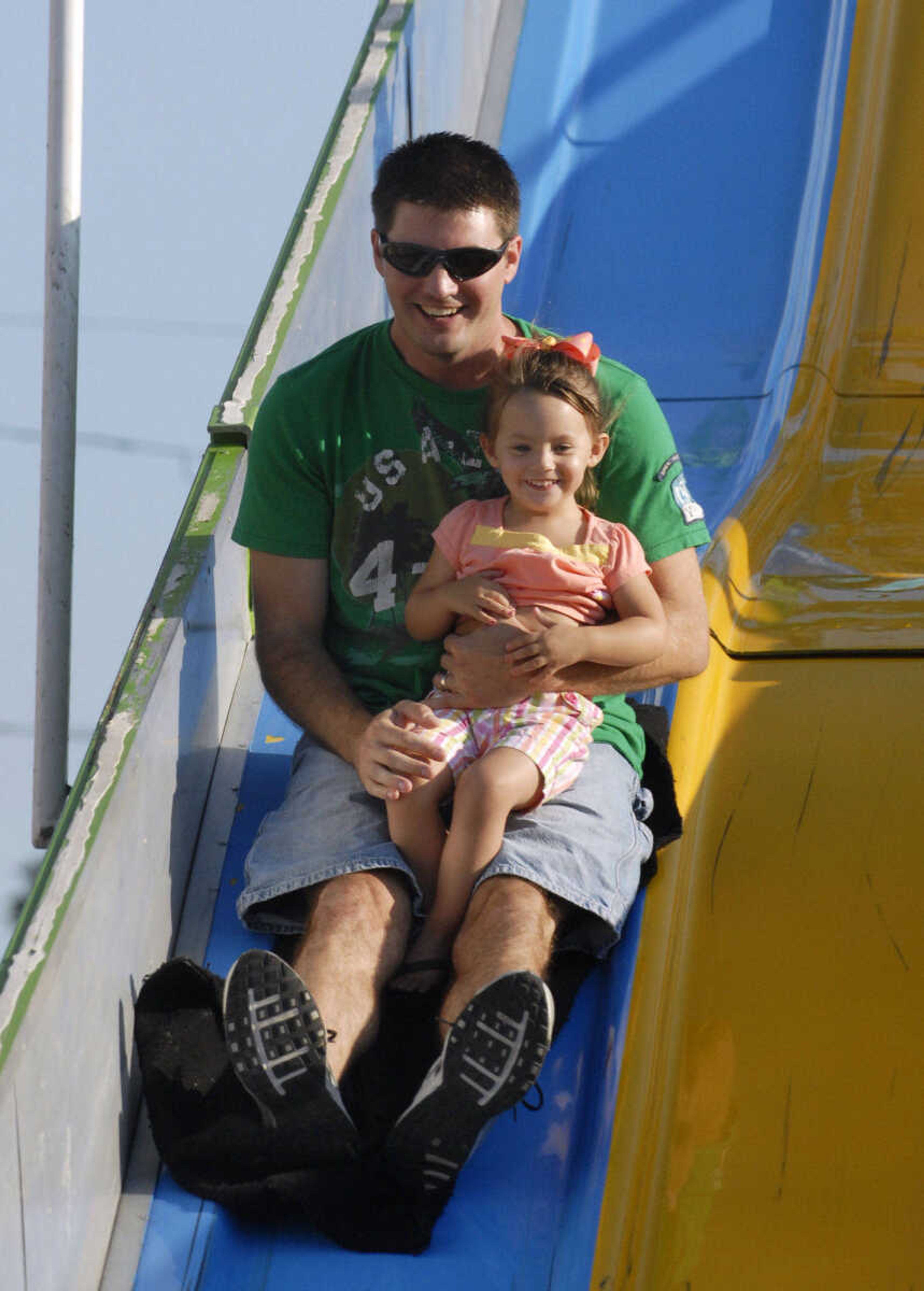 KRISTIN EBERTS ~ keberts@semissourian.com

Katie Heacox, 2, flies down the slide with father Kris Heacox at the 102nd Annual Homecomers Celebration in downtown Jackson on Tuesday, July 27, 2010. Tuesday marked the opening day of the celebration, which lasts through Saturday.