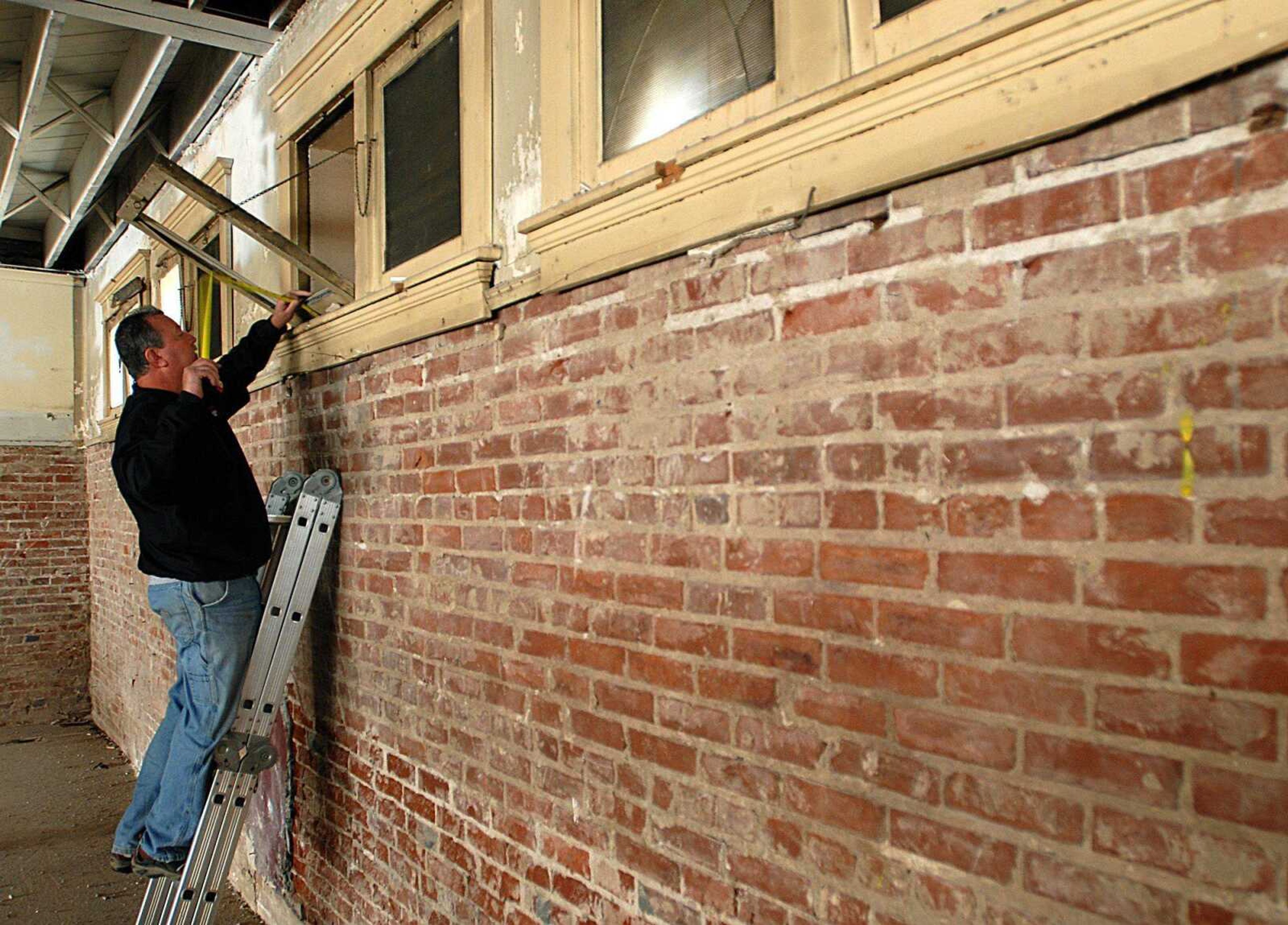 AARON EISENHAUER ~ aeisenhauer@semissourian.com
Terry Steele of Jackson Door and Glass measures windows on the main level of the new Discovery Playhouse building as renovations continue on Tuesday, October 21, 2008.