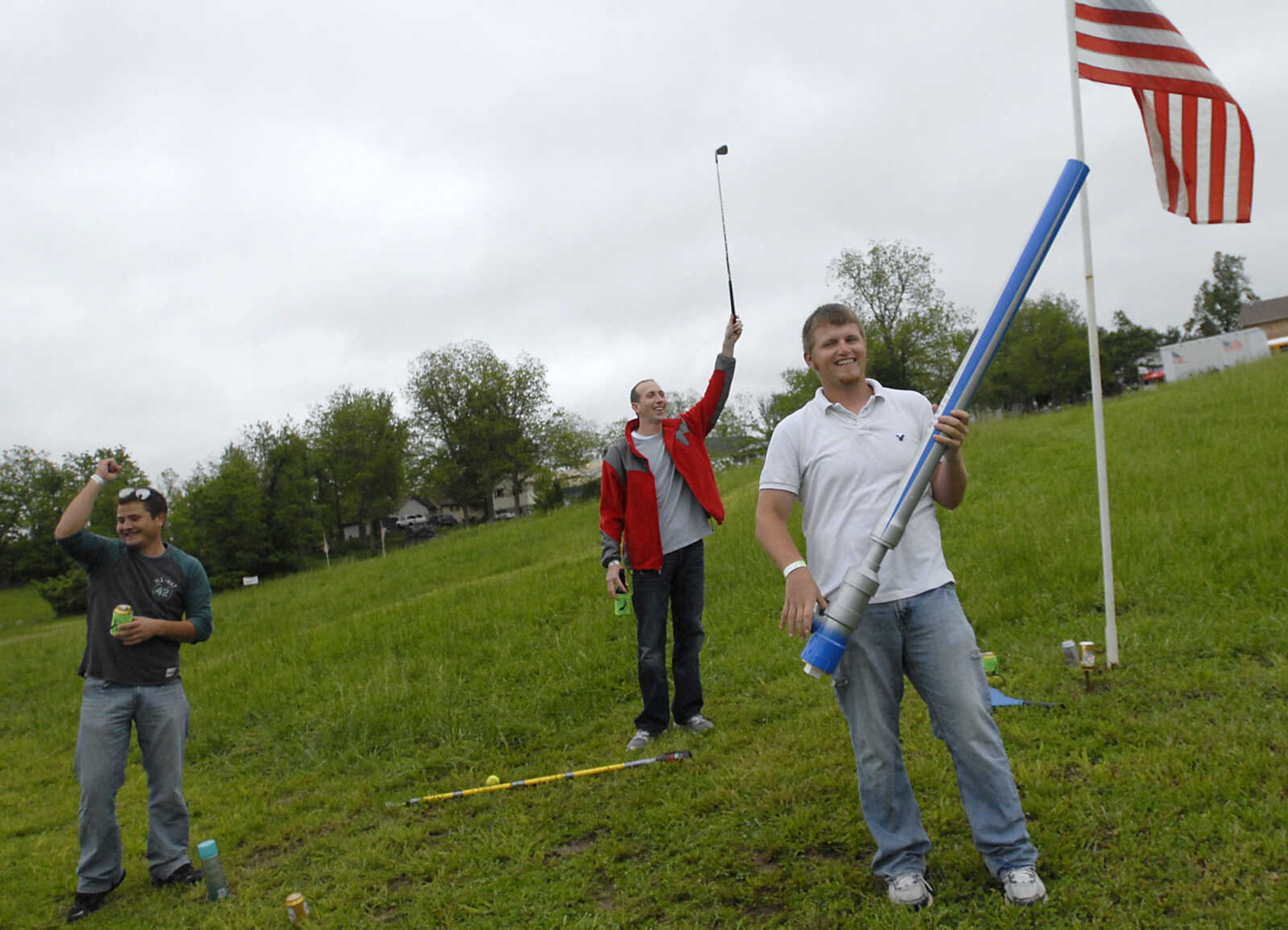 KRISTIN EBERTS ~ keberts@semissourian.com

Teammates Ryan Ortbals, left, and Corey Rentfrow, center, celebrate a good shot by Brandon Raithel, right, using a potato gun during the Kow Pasture Klassic at Schlinder's Tavern in New Hamburg, Mo., on Saturday, May 14, 2011. Proceeds from the event benefit the Kenny Rogers Children's Center and the Missouri Veterans Home.