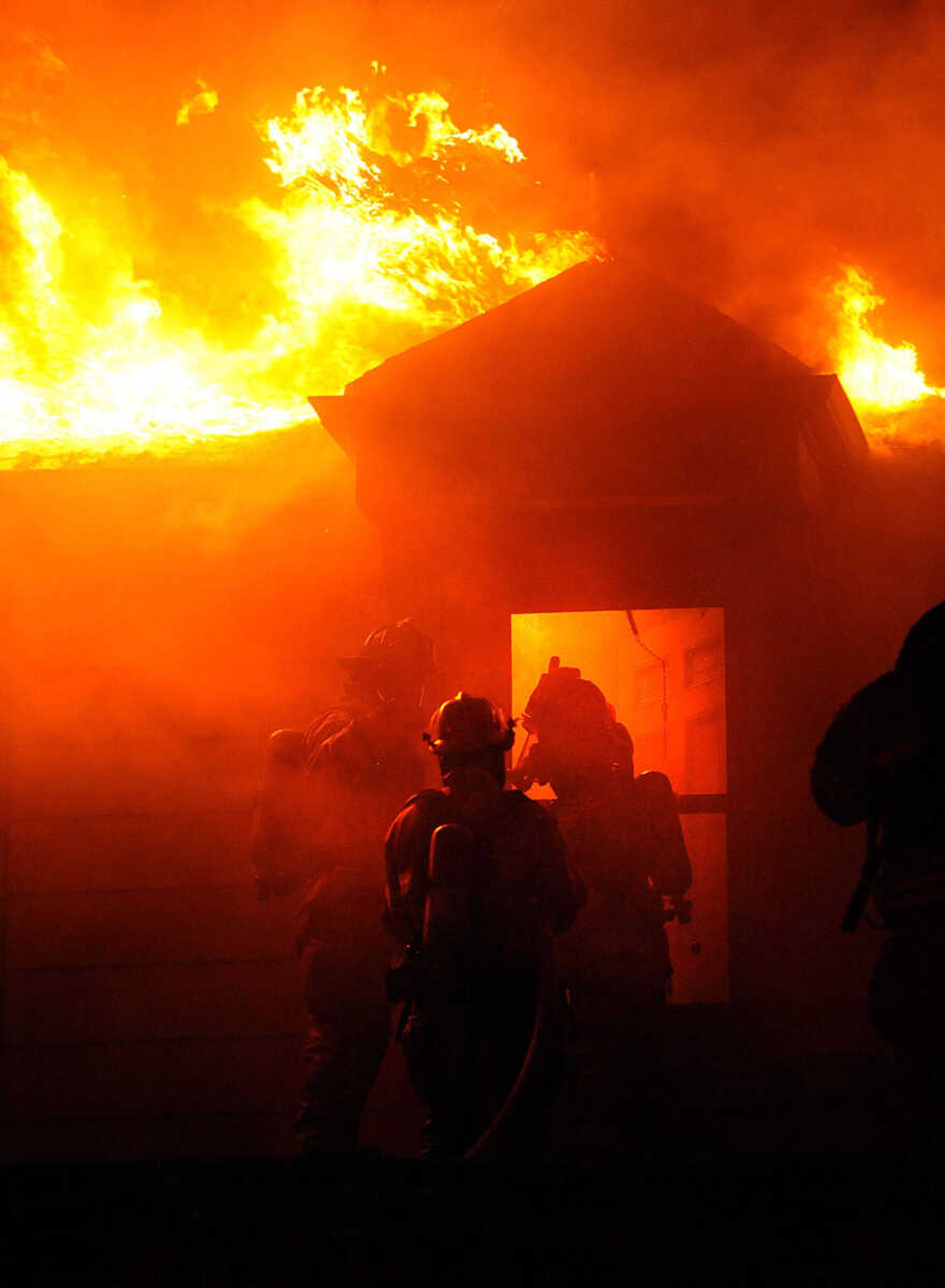 LAURA SIMON ~ lsimon@semissourian.com
Firefighters from Delta, Gordonville, Cape Girardeau, Millersville, Fruitland and East County Fire Departments battle a structure fire Wednesday night, January 9, 2012 on Onyx Lane in Cape Girardeau.