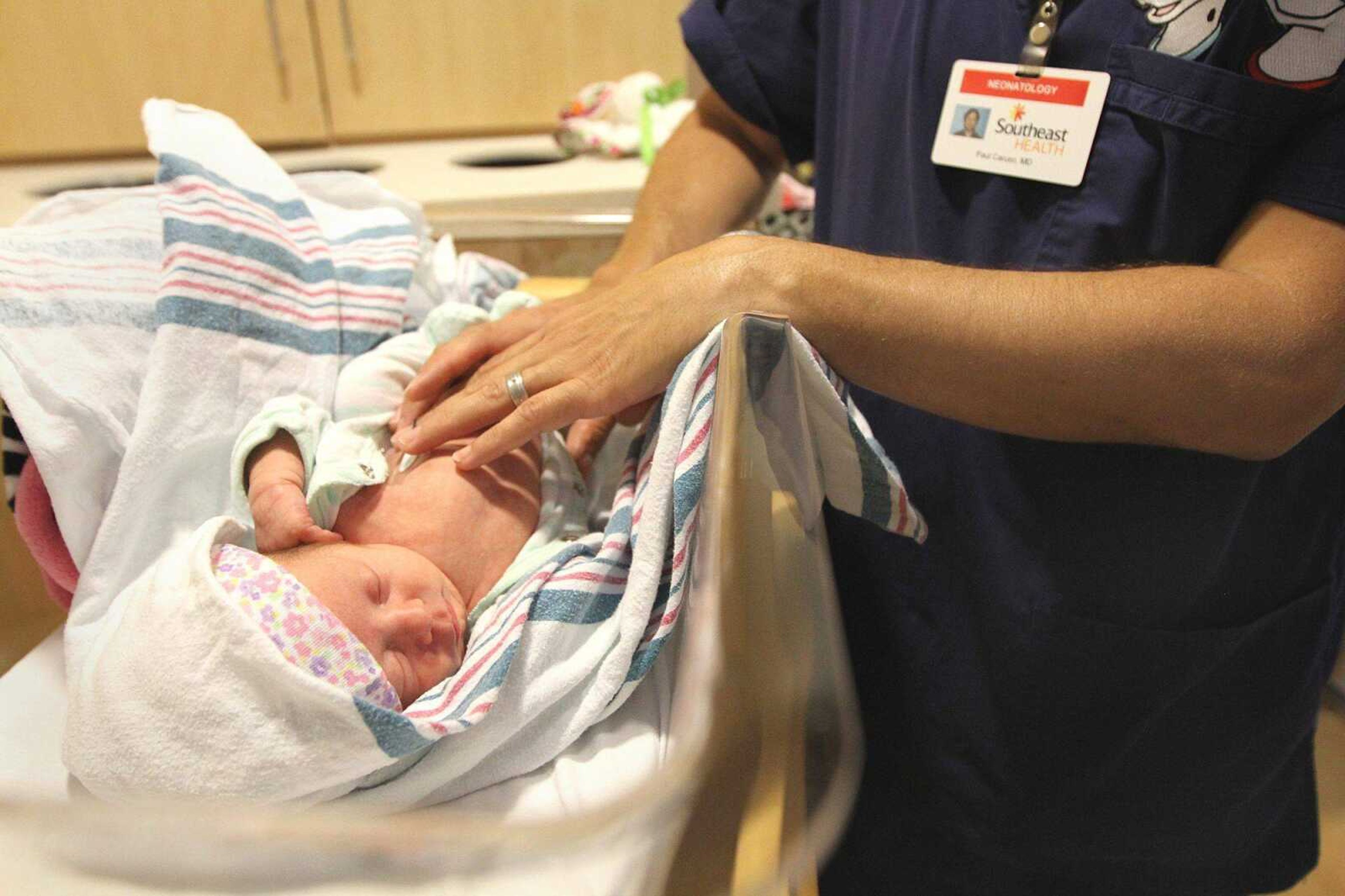 Dr. Paul Caruso checks on Ameila Grace Williams, born July 5, who is scheduled to go home later this week. (GLENN LANDBERG)