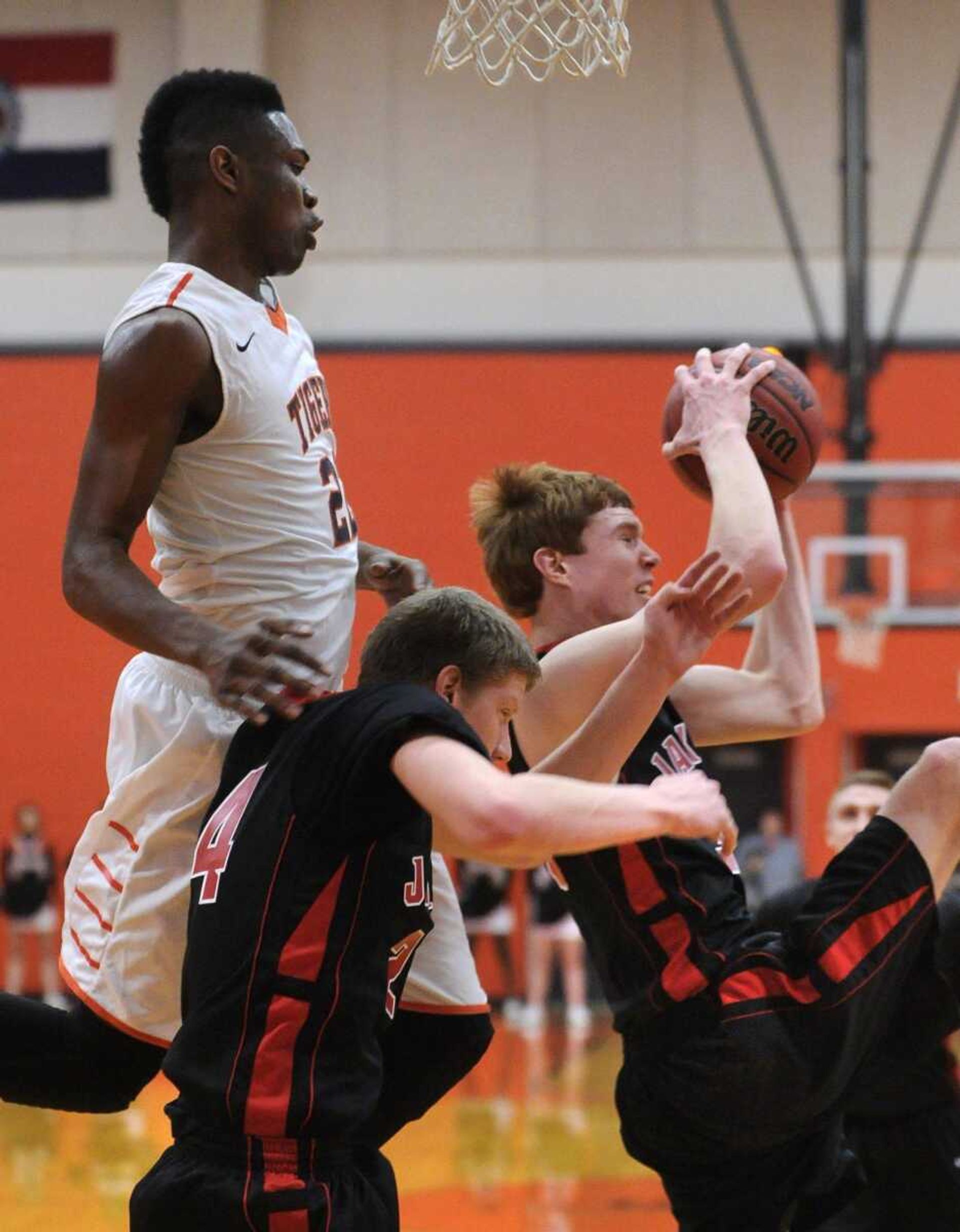 Jackson&#8217;s Brandon Lueders intercepts a lob pass intended for Central&#8217;s Jamal Cox, left, who was left hanging above Karson King, during the first quarter Tuesday at Central High School. (Fred Lynch)