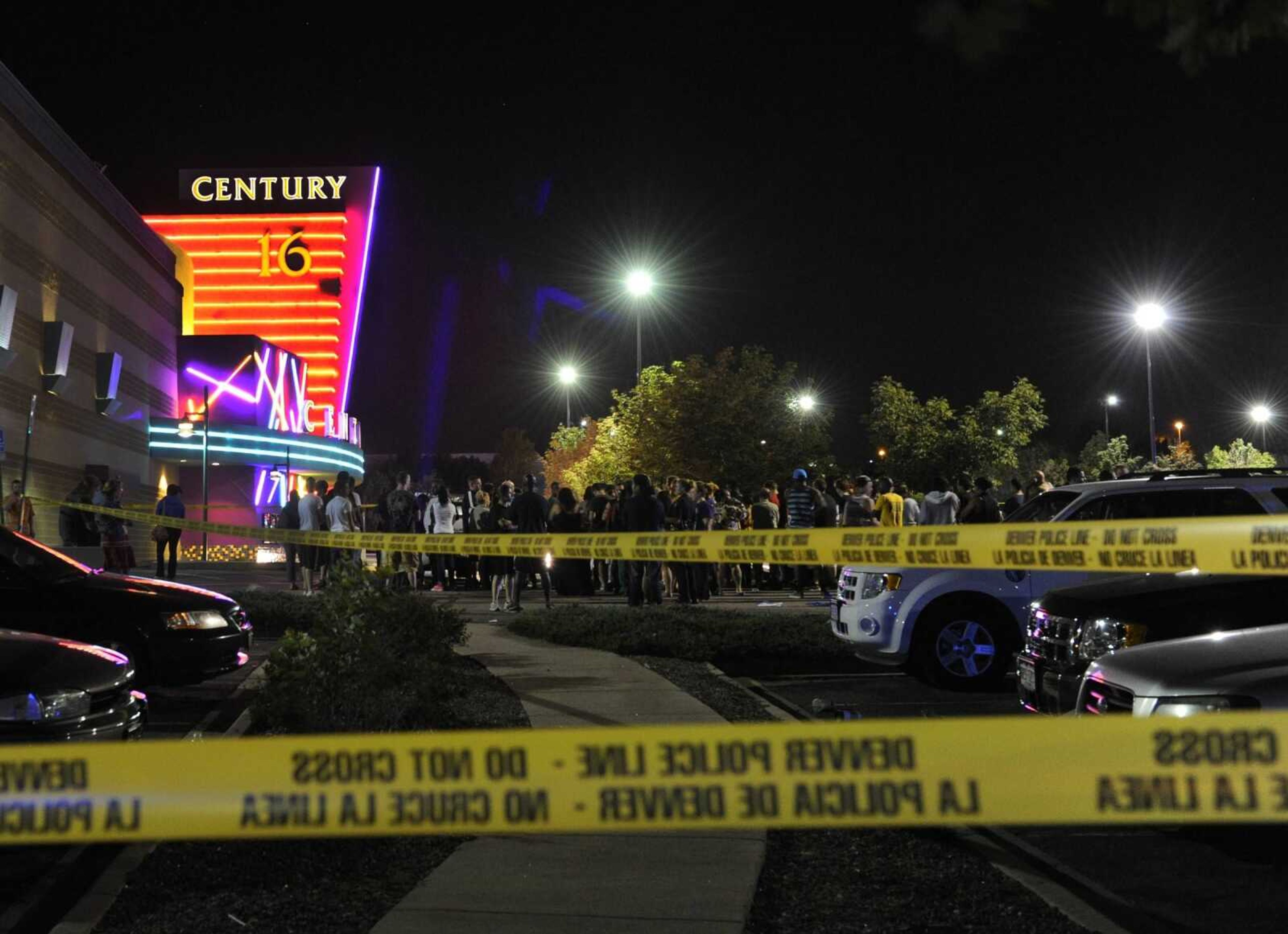 People gathered outside the Century 16 movie theater in Aurora, Colo., at the scene of a mass shooting early Friday morning. Police Chief Dan Oates said 14 people are dead following the shooting at the suburban Denver movie theater. He said 50 others were injured. (AP Photo/The Denver Post, Karl Gehring)