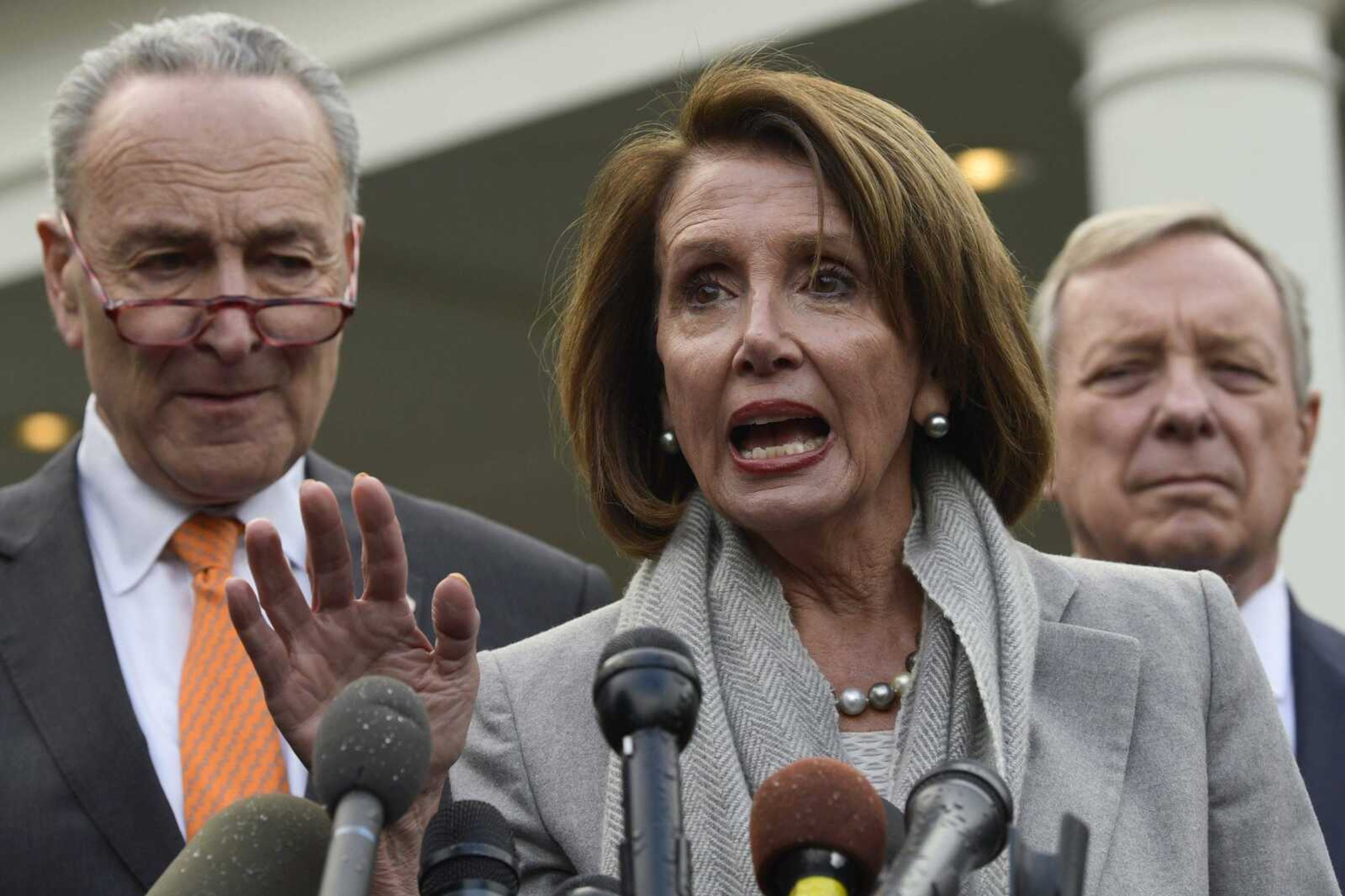 House Speaker Nancy Pelosi, center, speaks as she stands next to Senate Minority Leader Sen. Chuck Schumer, left, and Sen. Dick Durbin following their meeting Wednesday with President Donald Trump at the White House in Washington.