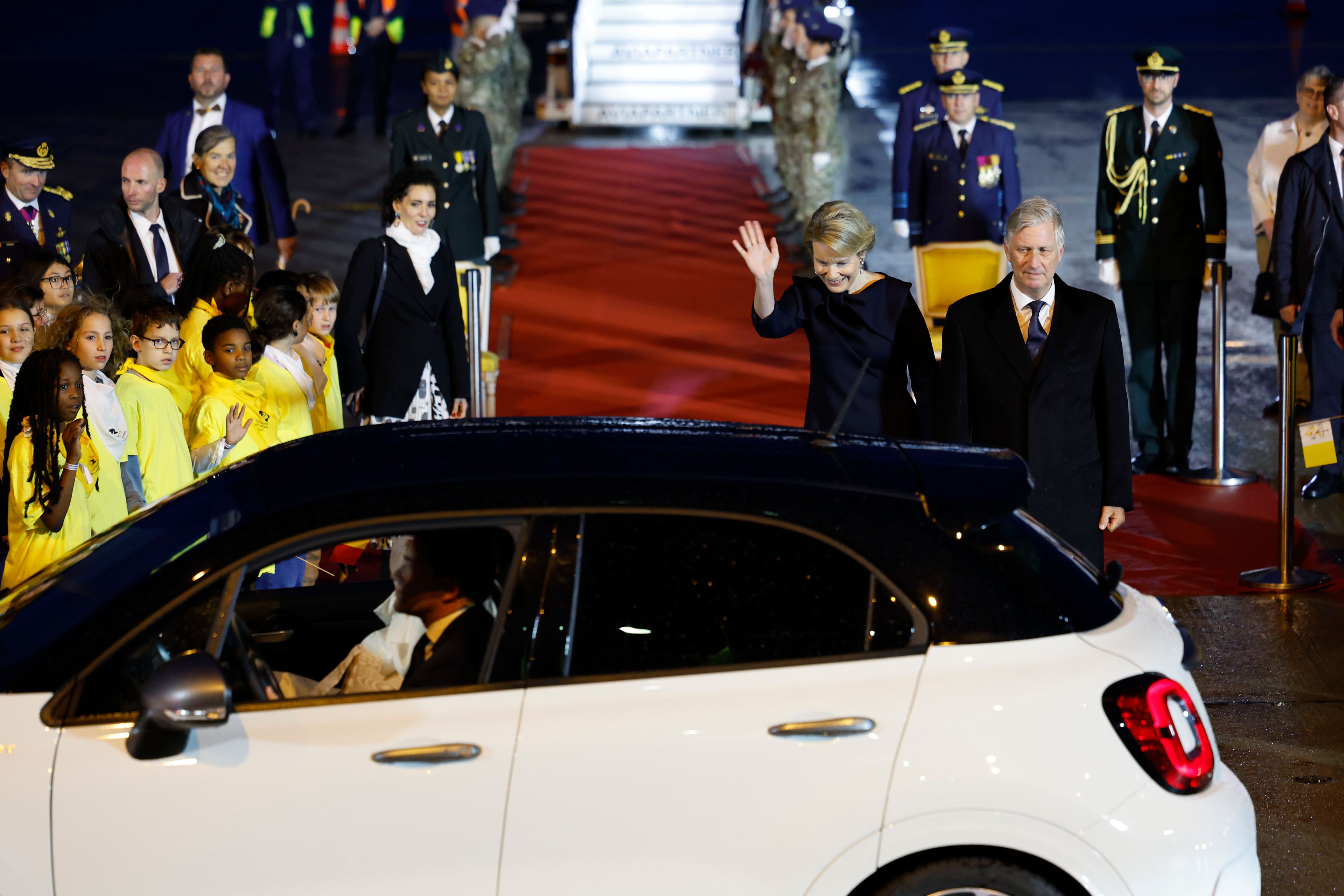 Queen Mathilde of Belgium and King Philippe of Belgium, at Melsbroek cheer Pope Francis leaving the air base in Steenokkerzeel, near Brussels, on the first day of his four-day visit to Luxembourg and Belgium, Thursday, Sept. 26, 2024. (AP Photo/Geert Vanden Wijngaert)