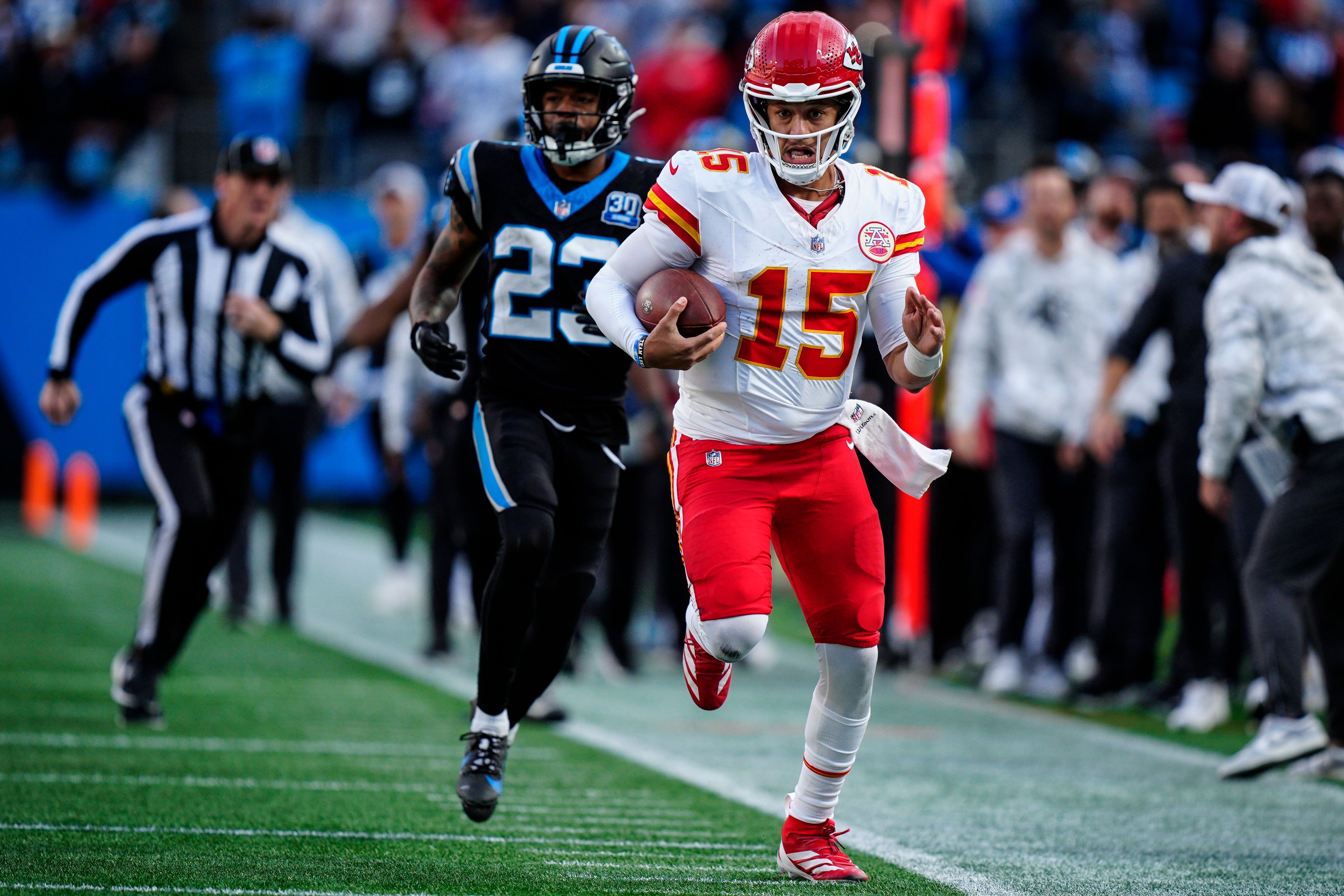 Kansas City Chiefs quarterback Patrick Mahomes (15) runs in overtime against the Carolina Panthers during an NFL football game, Sunday, Nov. 24, 2024, in Charlotte, N.C. (AP Photo/Jacob Kupferman)