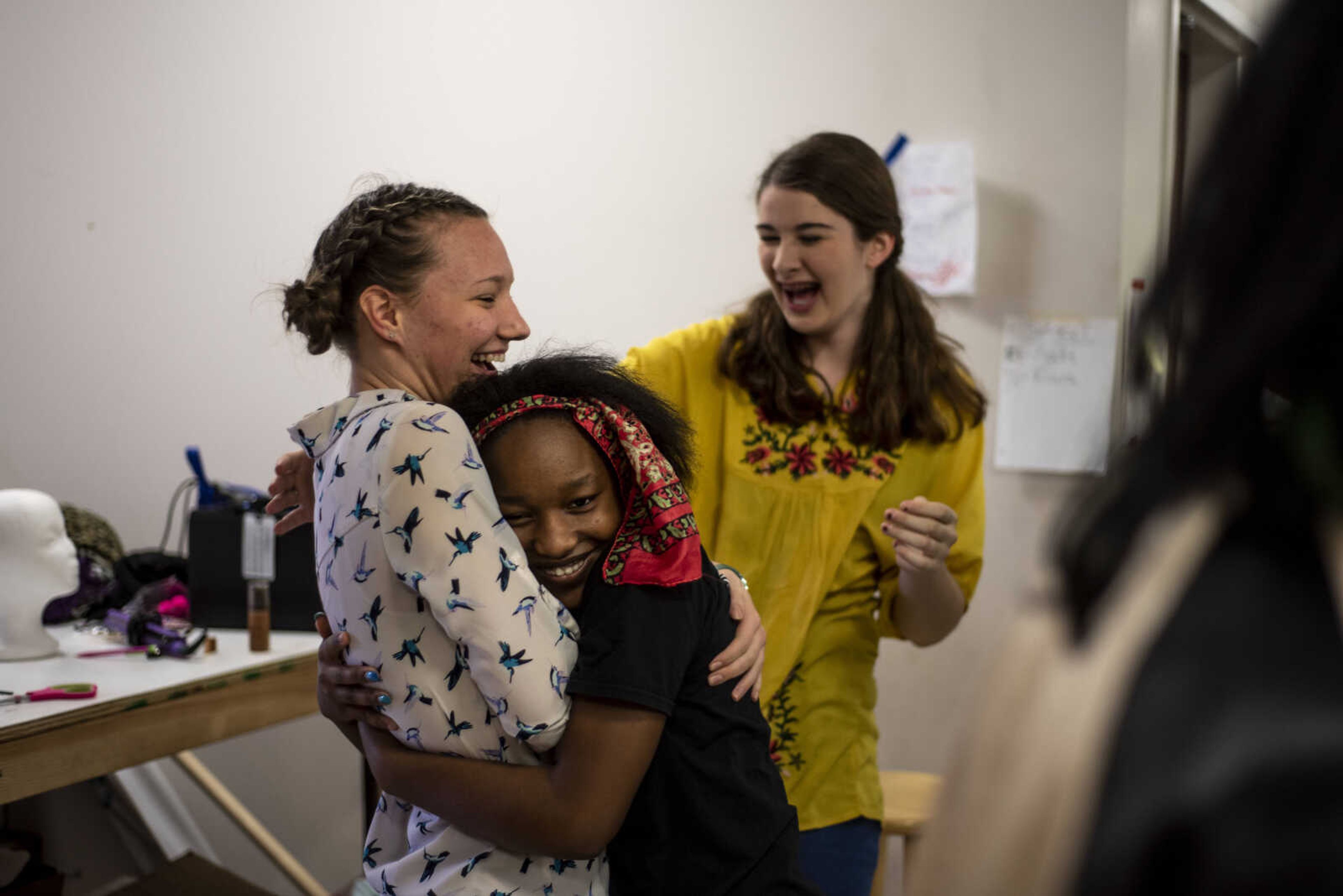 Quenaiyah Dickison, center, hugs Jacqui Lang as Emma Wolfe reacts to Lang's visit backstage during the media night of Cape Central High School's spring musical production of "Mamma Mia!" Wednesday, April 10, 2019, in Cape Girardeau.