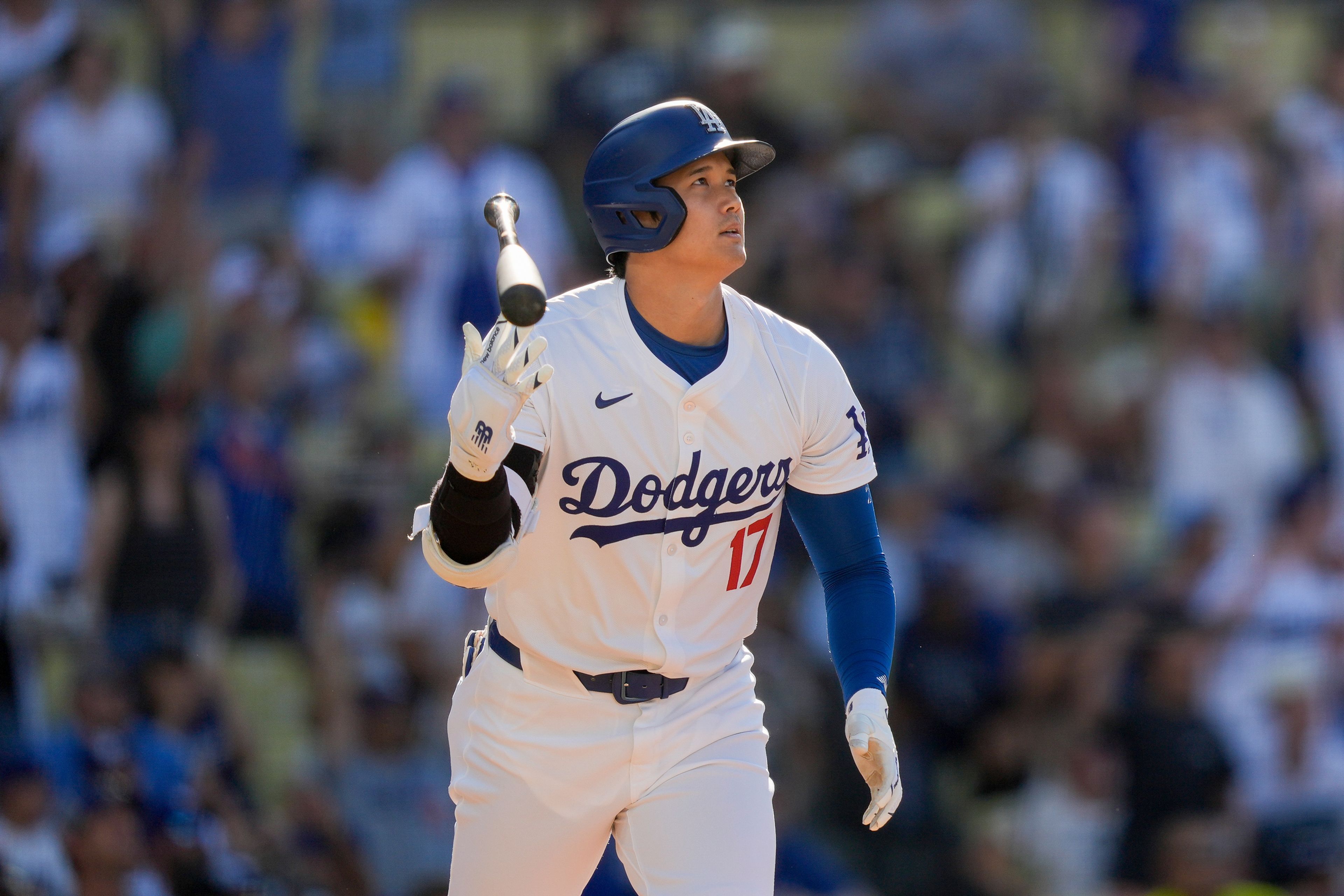 Los Angeles Dodgers designated hitter Shohei Ohtani tosses his bat after hitting a solo home run during the fifth inning of a baseball game against the Boston Red Sox, Sunday, July 21, 2024, in Los Angeles. (AP Photo/Ryan Sun)