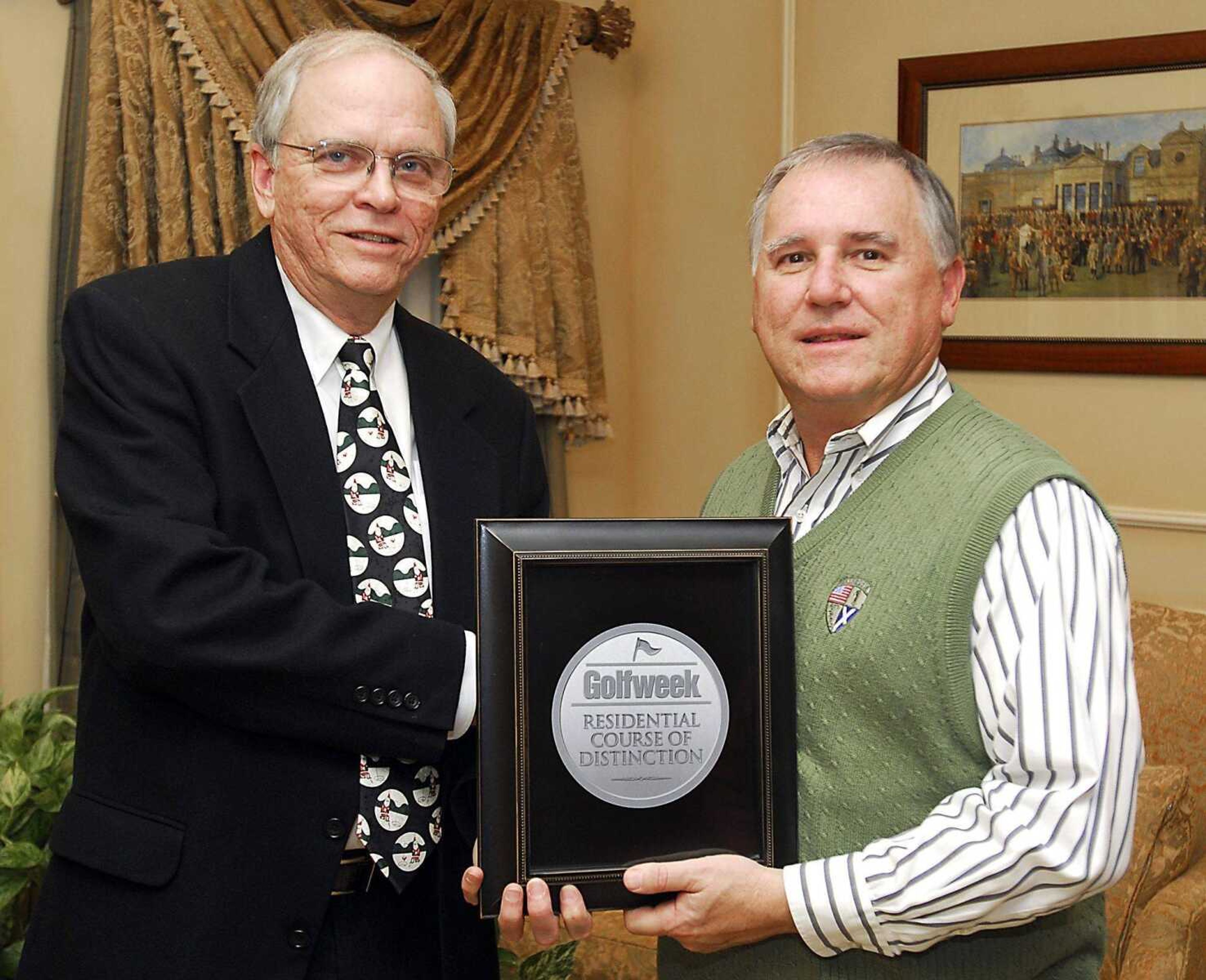 Cord Dombrowski, right, managing member for Dalhousie Golf Club, and Charles Wiles, a marketing consultant for the club, showed off the Golfweek Residential Course of Distinction plaque prior to Tuesday's announcement. Dalhousie was named by Golfweek as one of the top 121 golf courses in the nation with a residential development (Fred Lynch)