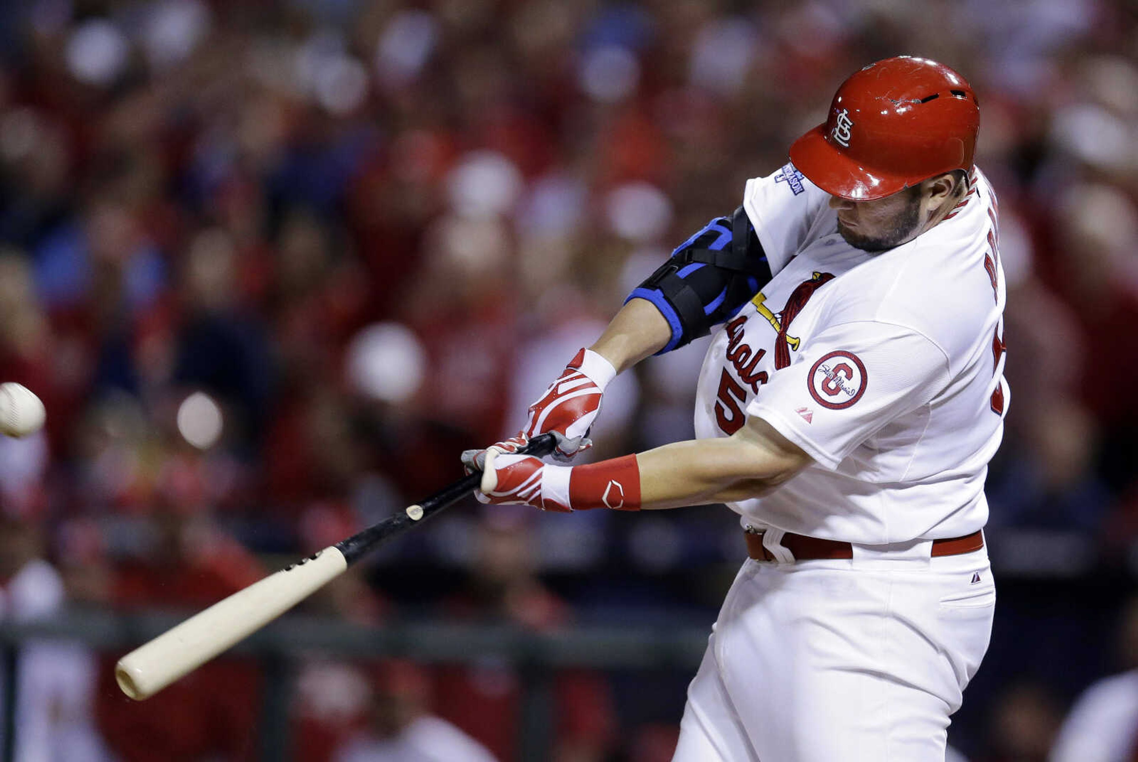 St. Louis Cardinals' Matt Adams hits a two-run home run against the Pittsburgh Pirates in the bottom of the eighth inning in Game 5 of a National League baseball division series, Wednesday, Oct. 9, 2013, in St. Louis. (AP Photo/Charlie Riedel)