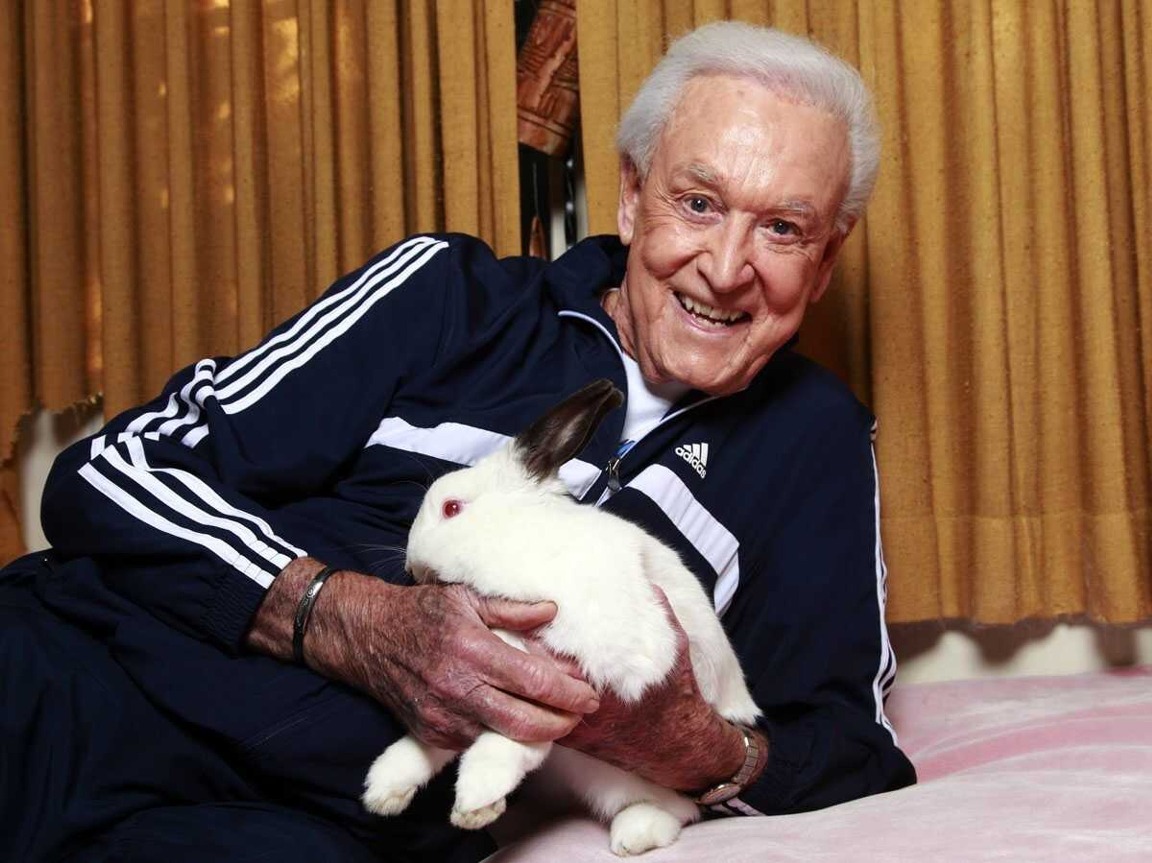 Retired game show host Bob Barker holds Mr. Rabbit at his home in Los Angeles on Dec. 13. (Damian Dovarganes ~ Associated Press)