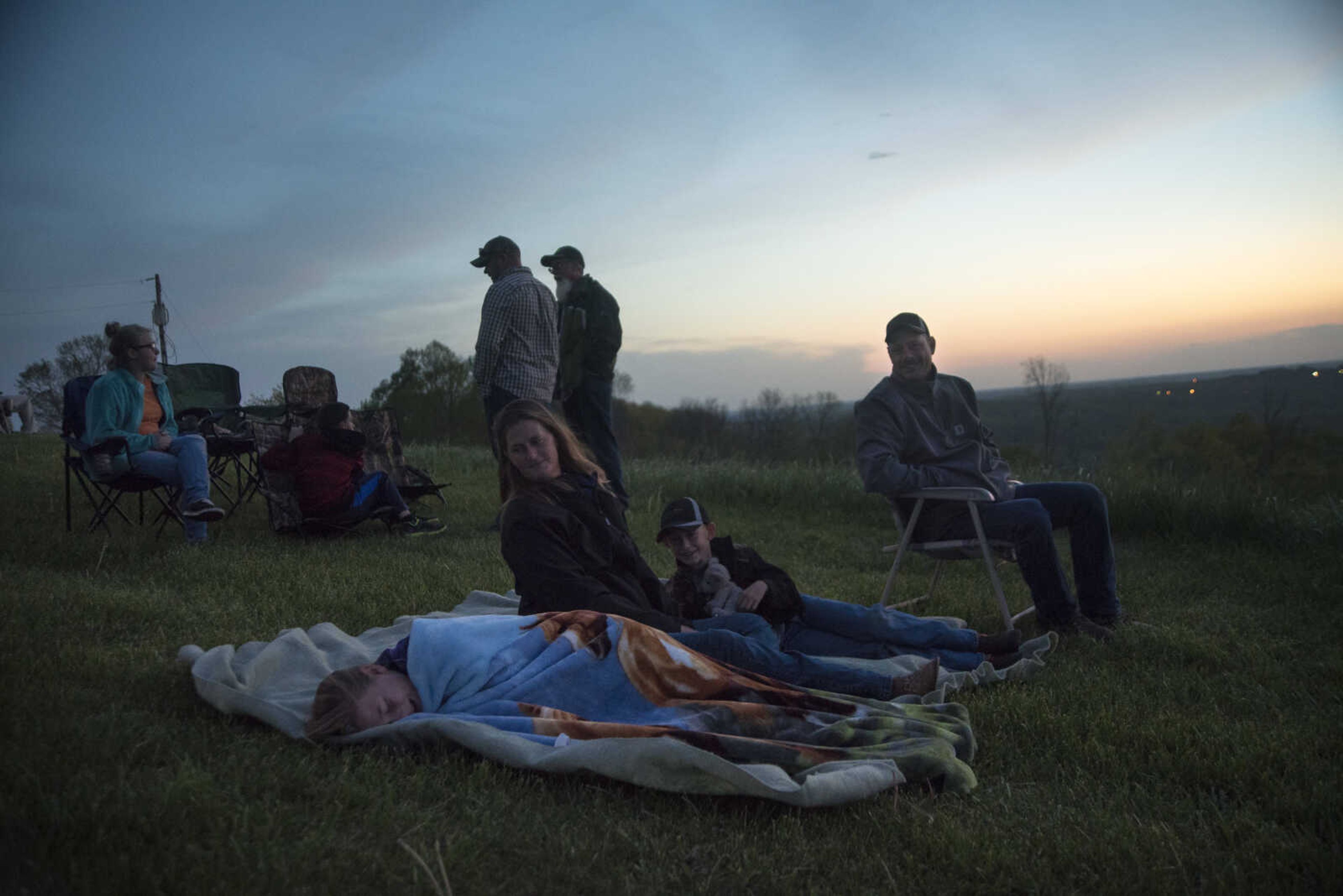 People sit on the lawn with blankets and chairs during the 81st annual Easter Sunrise Service at the Bald Knob Cross of Peace Sunday, April 16, 2017 in Alto Pass, Illinois.