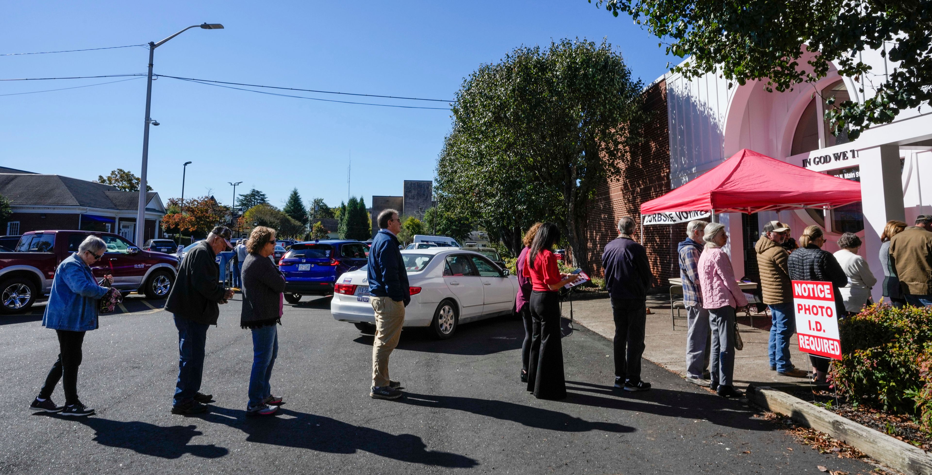 A steady line of voters wait to vote at the Rutherford County Annex Building on the first day of early voting, Thursday, Oct. 17, 2024 in Rutherfordton, N.C. (AP Photo/Kathy Kmonicek)