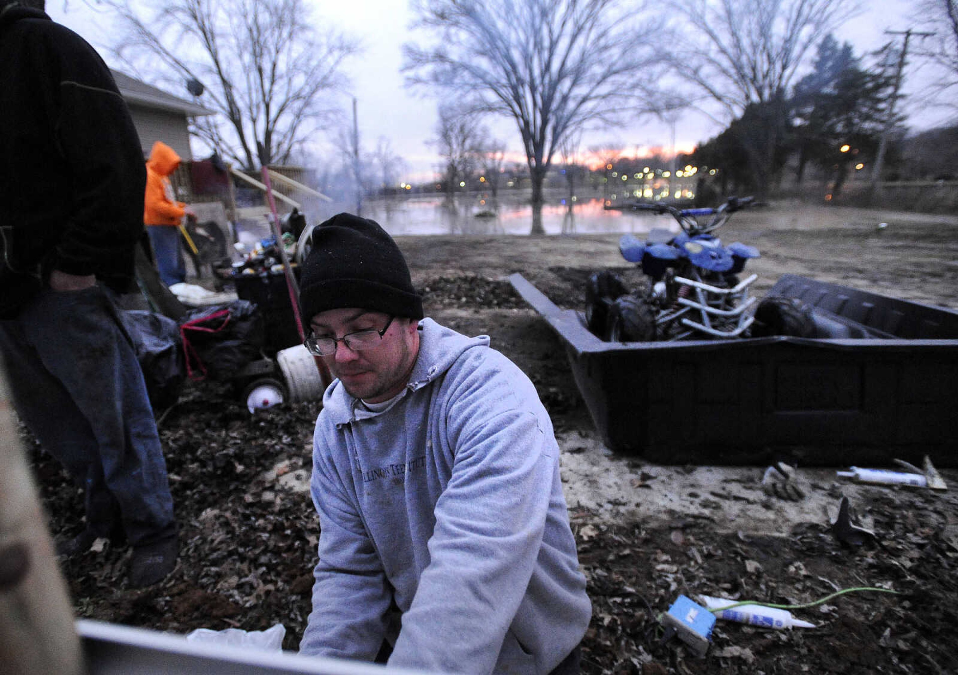 LAURA SIMON ~ lsimon@semissourian.com

Matt Butler works on a tin fence to surround a workshop near the Red Star Access in Cape Girardeau Tuesday evening, Dec. 29, 2015. Flooding from the Mississippi River is encroaching on the shop.