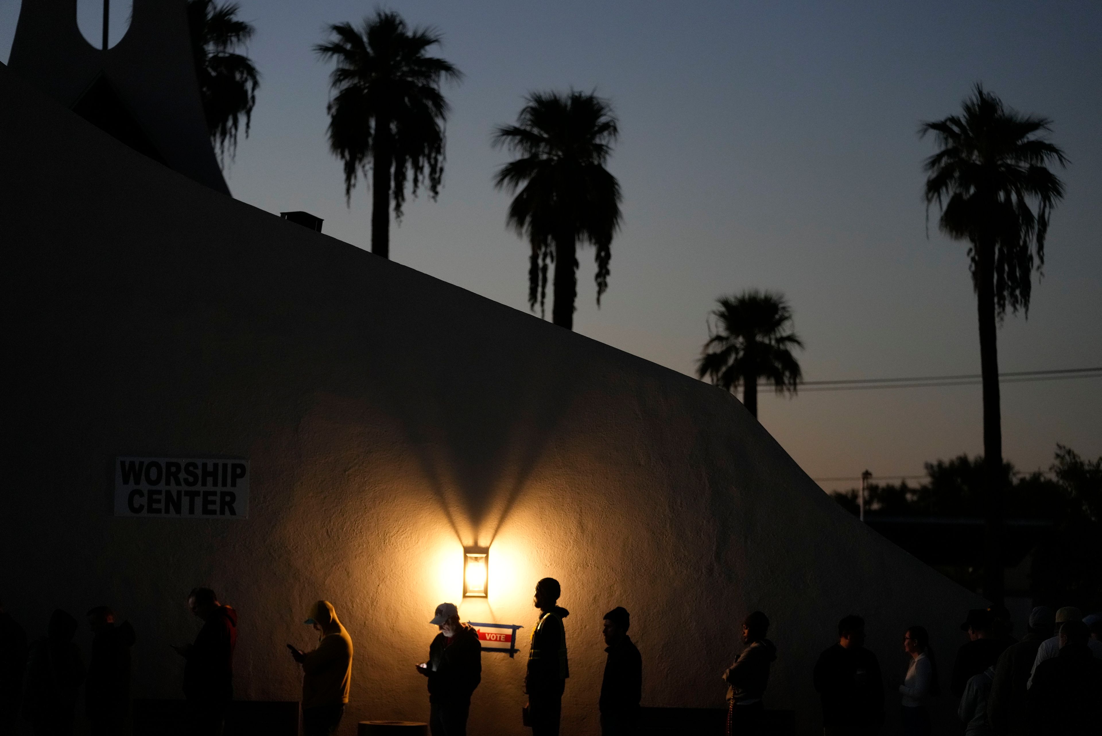 Voters stand in line outside a polling place at Madison Church, Tuesday, Nov. 5, 2024, in Phoenix, Ariz. (AP Photo/Matt York)