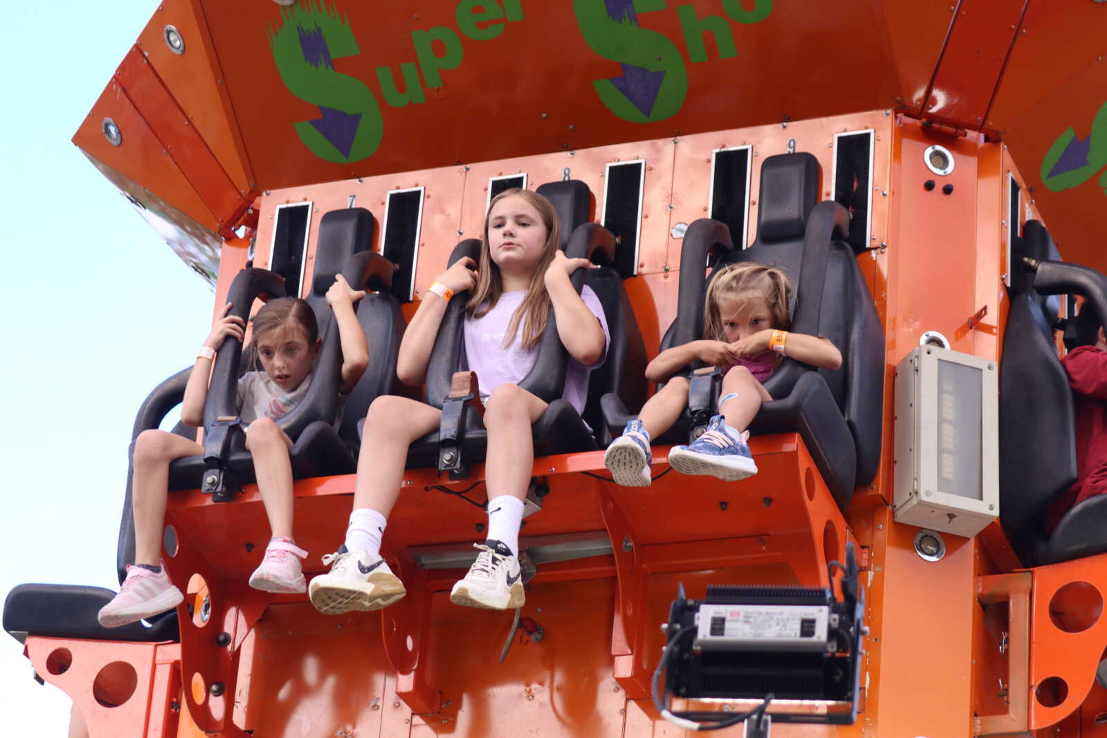 From left, Emme Hill, Linley Wallis and Brynlee Hill ride the Super Shot ride Friday, Aug. 30, at the 55th annual Benton Neighbor Day festival in Benton. More photos are in a gallery at semissourian.com.