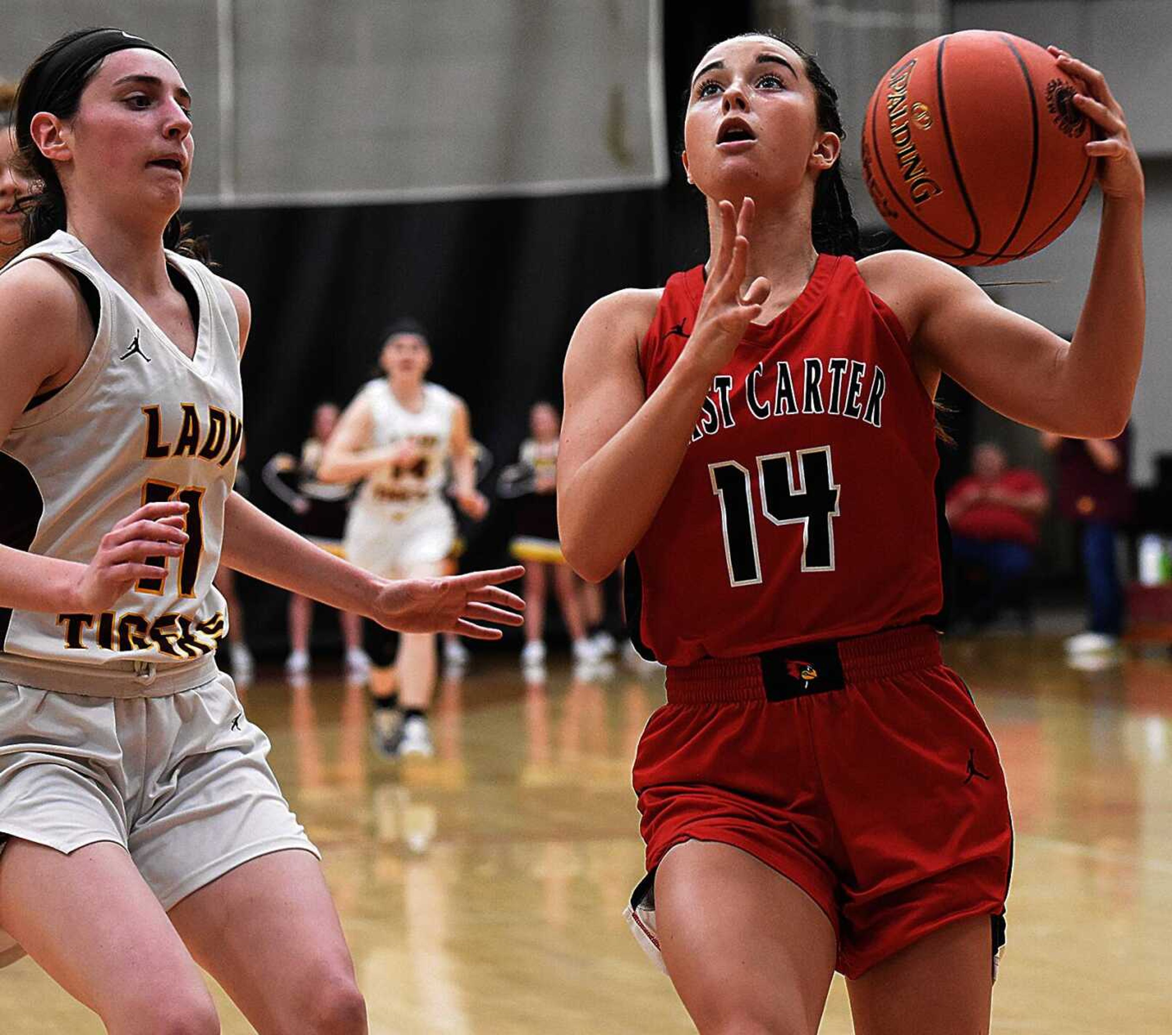 East Carter�s Brooklyn Kearbey (right) drives to the basket as she is guarded by Neelyville�s Jade Crosswhite during Tuesday�s MSHSAA Class 2 sectional at the Sikeston Field House.