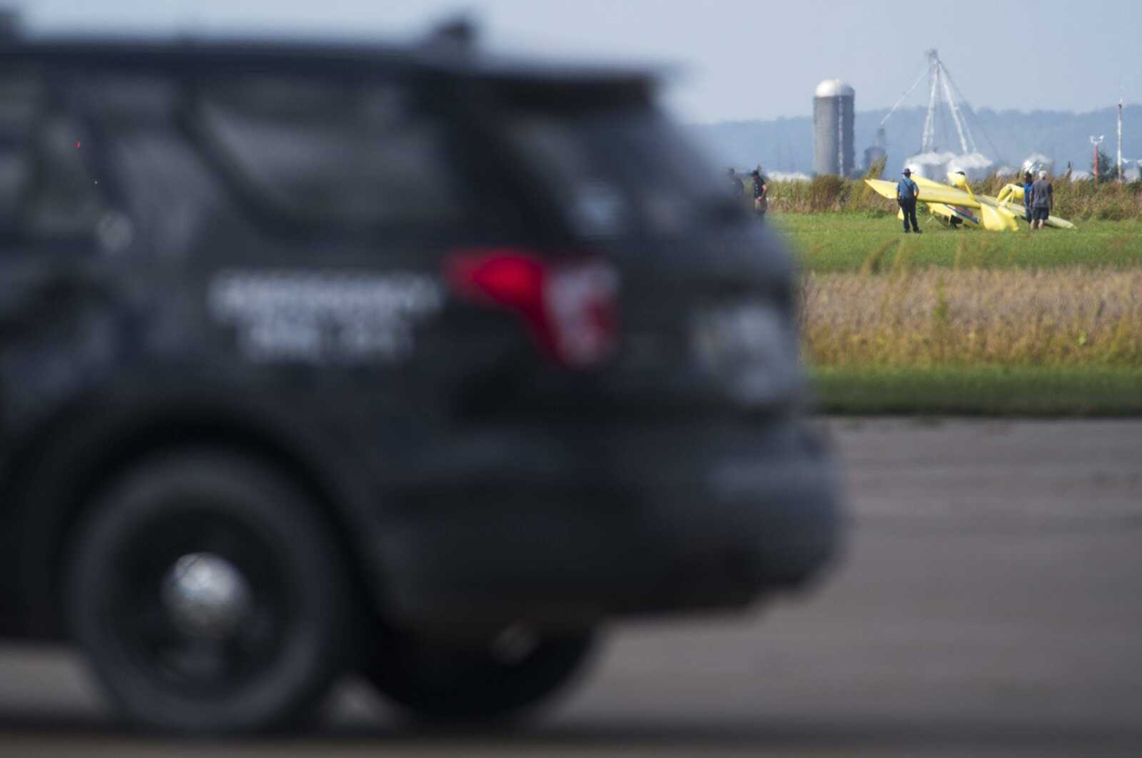 A Cape Girardeau Sheriff's Department vehicle drives on the runway as emergency personnel respond to the scene of an overturned airplane Tuesday, Oct. 9, 2018, at the Cape Girardeau Regional Airport. According to a media release from the City of Cape Girardeau, the aircraft was carrying two passengers when it flipped at 11 a.m. and both passengers are being transported to local hospitals for treatment of serious injuries.